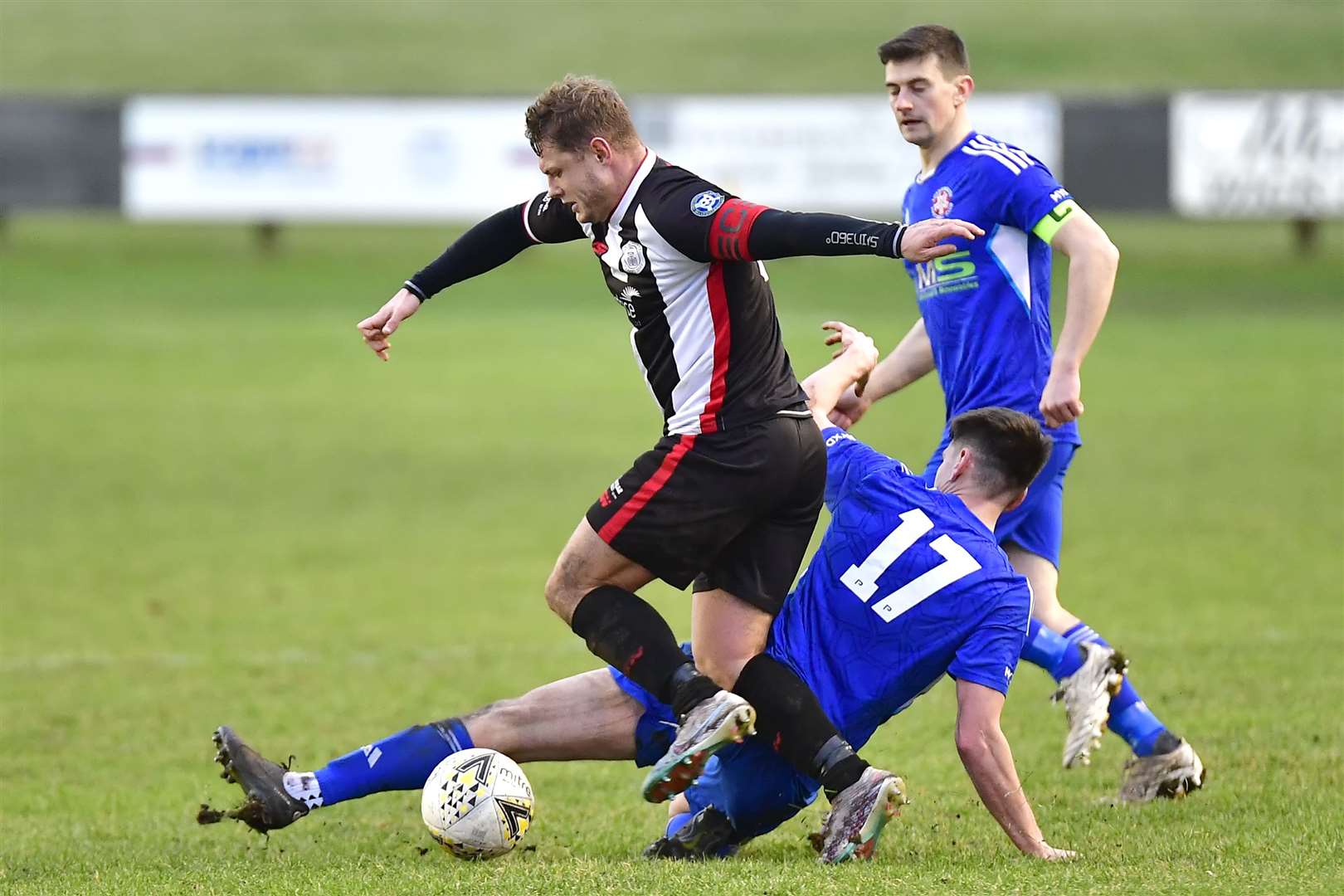 Lossiemouth's Jared Kennedy slides in to try and stop Wick captain Jack Halliday. Picture: Mel Roger