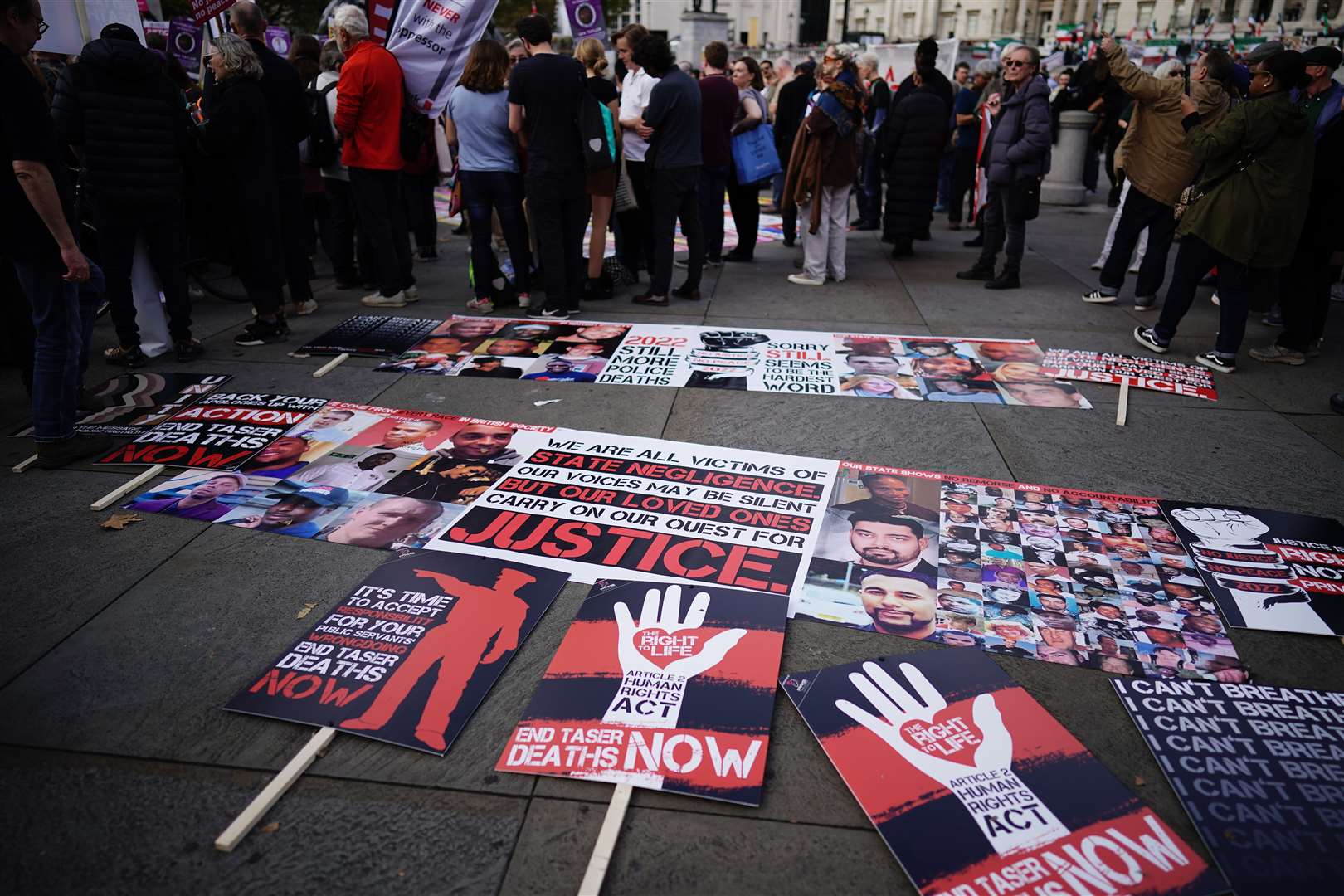 The protesters lay their placards down at the end of the march (Aaron Chown/PA)