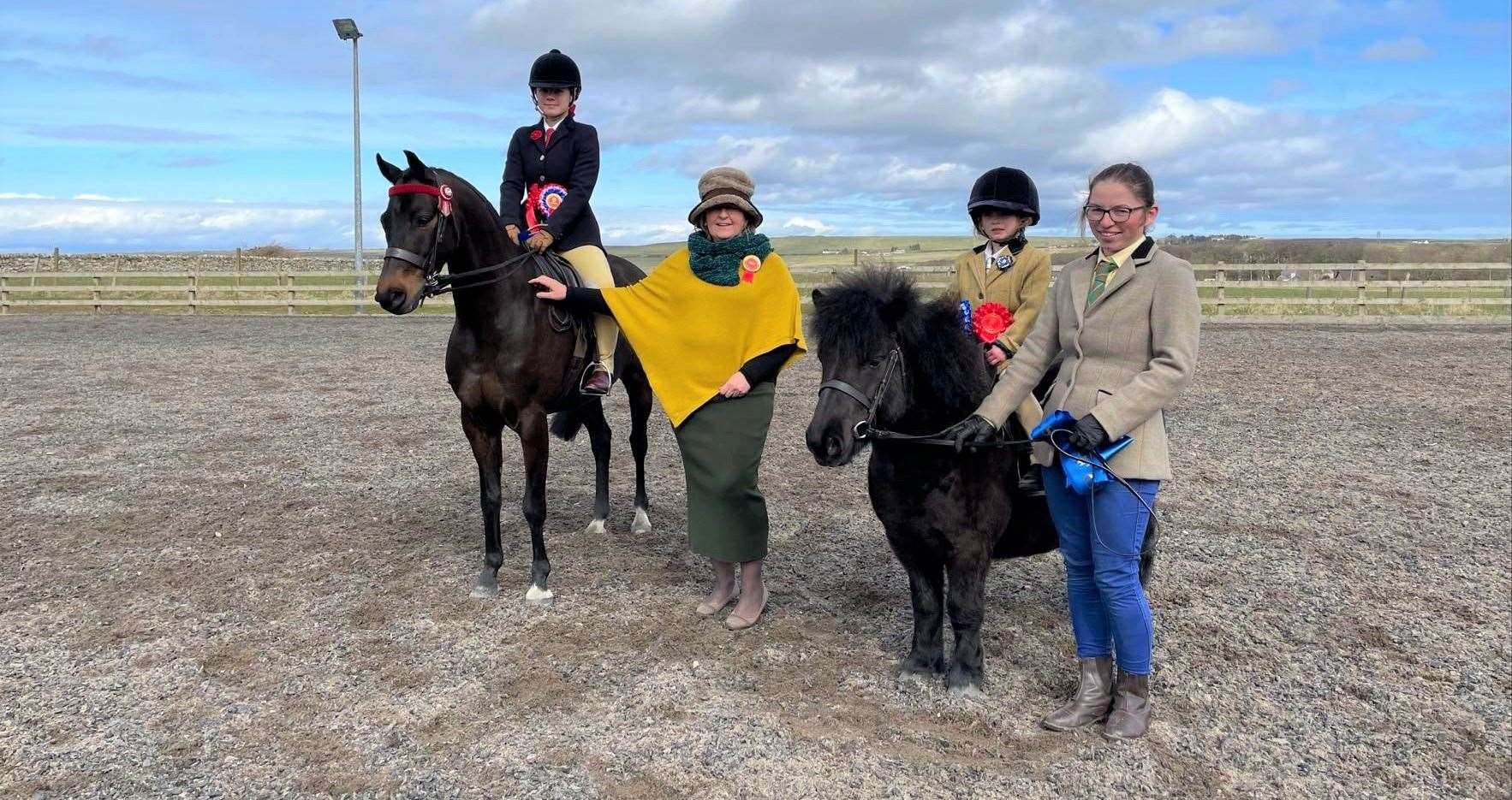 Ridden judge Karen Mowat with the pony champion Leoni Kennedy and Shanrye Finley (left) and reserve Harriet Taylor with Farnorth Black Magnus, led by mum Emma.