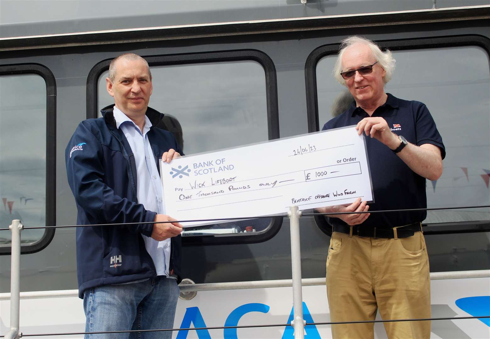 Alan Paul (left), control room manager at the Beatrice base in Wick, handing over a cheque for £1000 from the offshore wind farm to Murray Lamont, chairman of the Wick lifeboat management committee, during the annual Harbour Day at the weekend. Picture: Alan Hendry