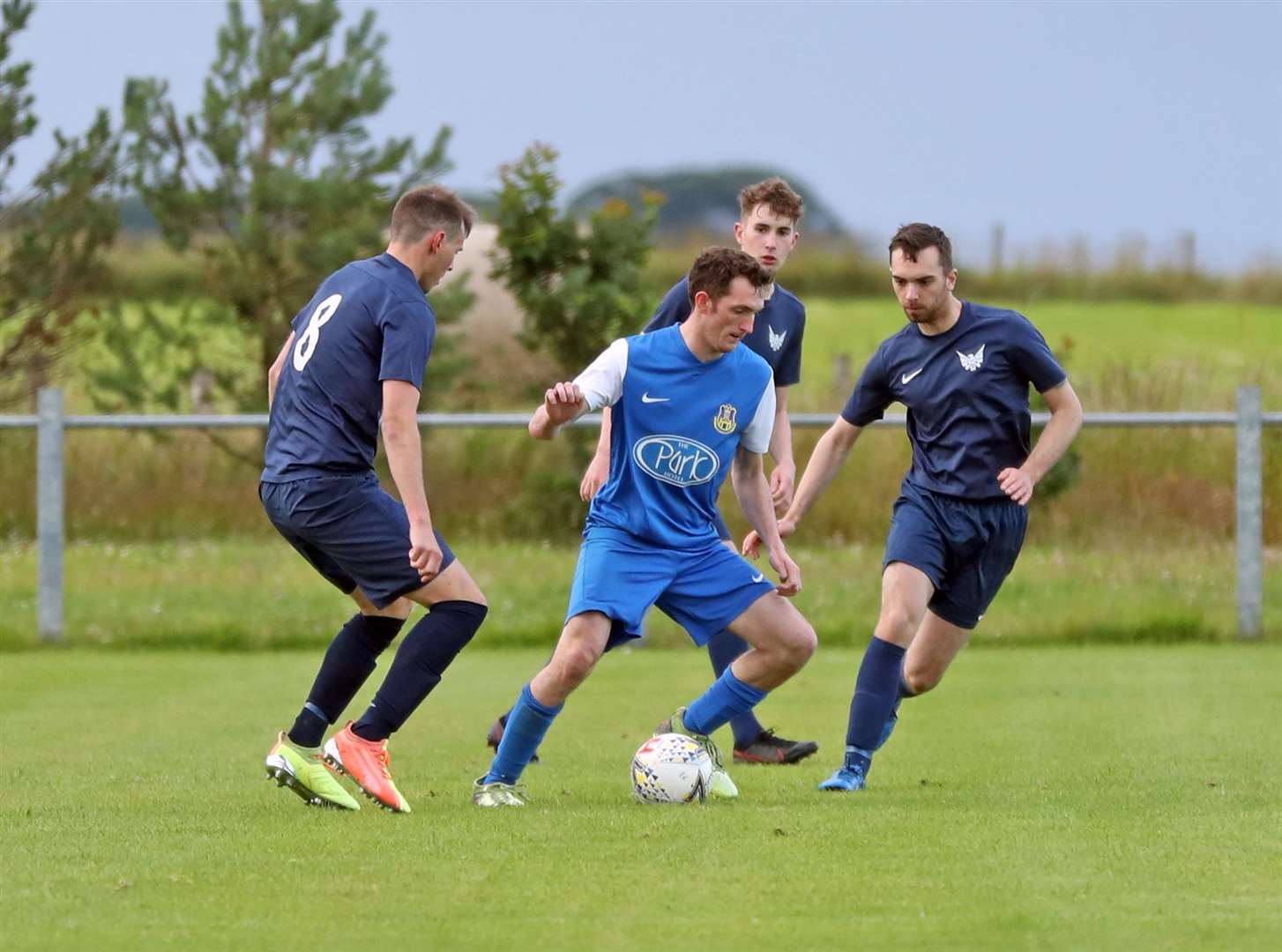 Acks' hat-trick hero Kyle Innes is surrounded by High Ormlie Hotspur players on Monday night. A 4-1 win allowed Acks to move up to fifth place. Picture: James Gunn