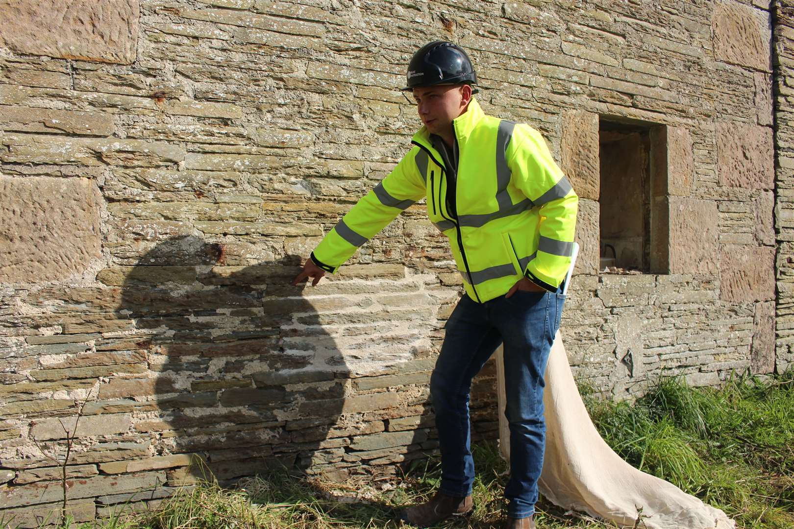 Jamie Rogers points out some of the lime mortar work that is being tested. Picture: John Davidson