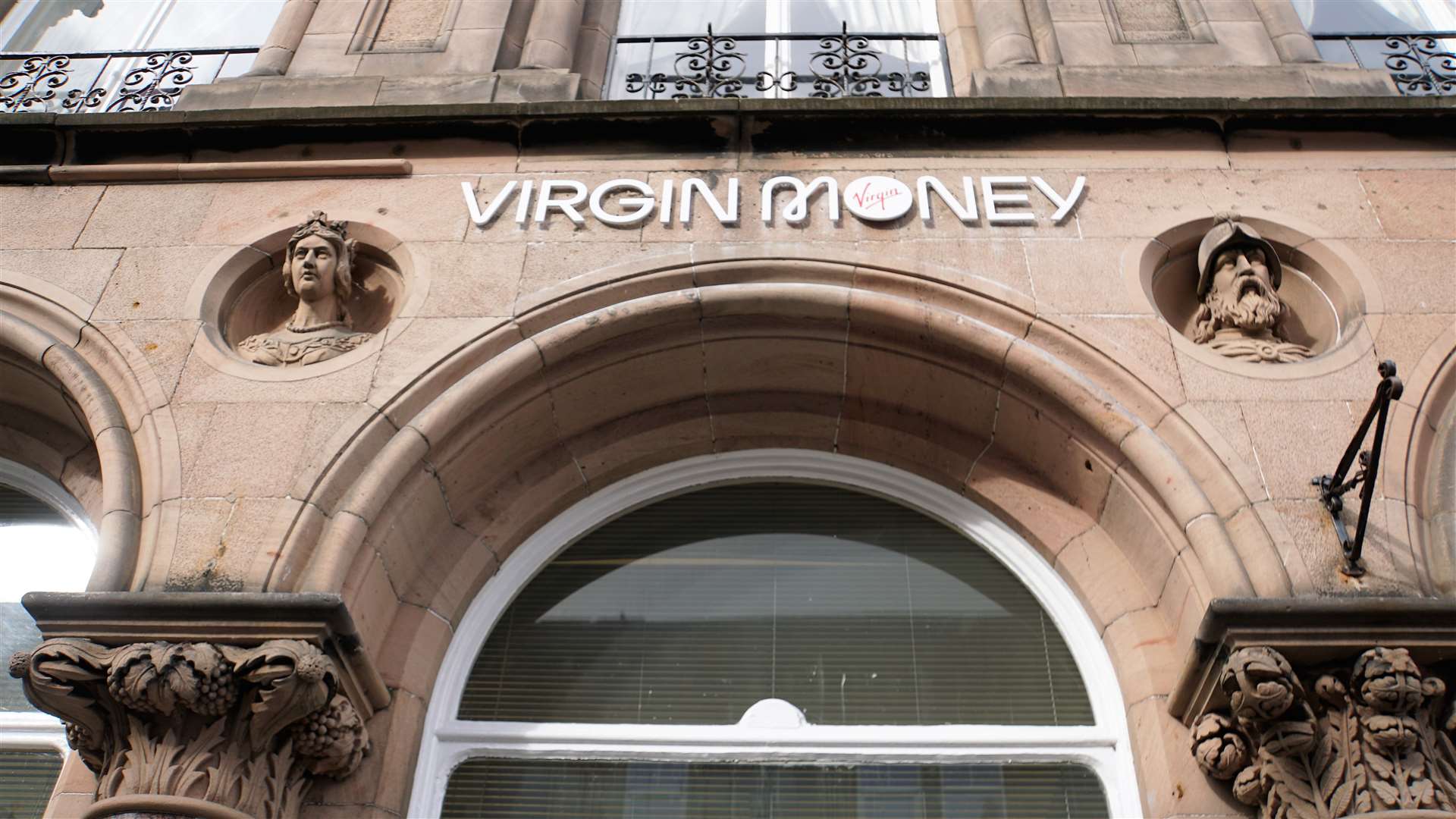 Busts of Queen Victoria and Robert the Bruce flank the new Virgin Money sign that was installed on the Bridge Street building this week.