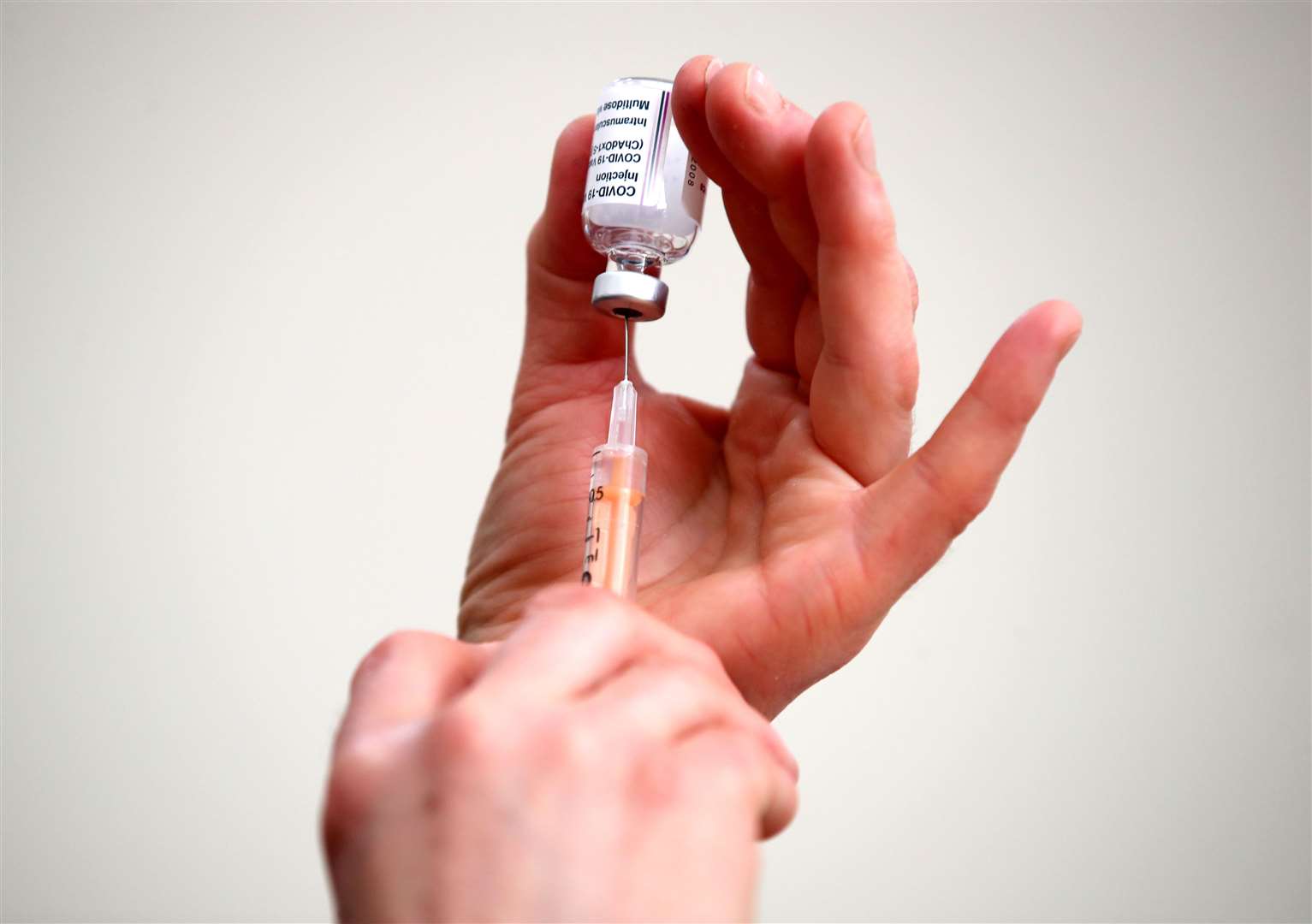 A doctor fills a syringe with a dose of the Oxford/AstraZeneca coronavirus vaccine (Nick Potts/PA)