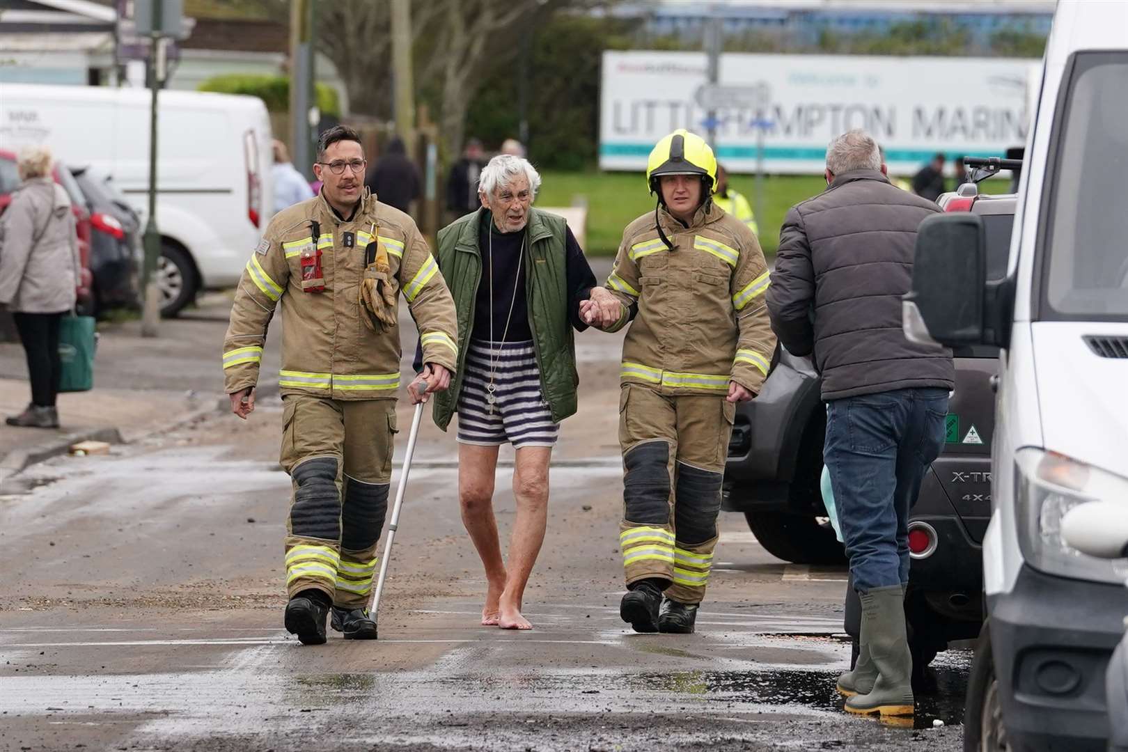 Firefighters evacuate an elderly resident near Rope Walk in Littlehampton (Gareth Fuller/PA)