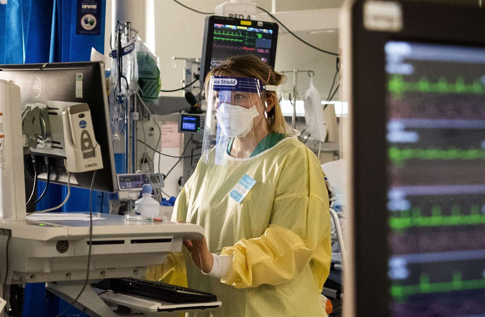 A nurse monitors the progress of patients on a computer in the ICU (Victoria Jones/PA)