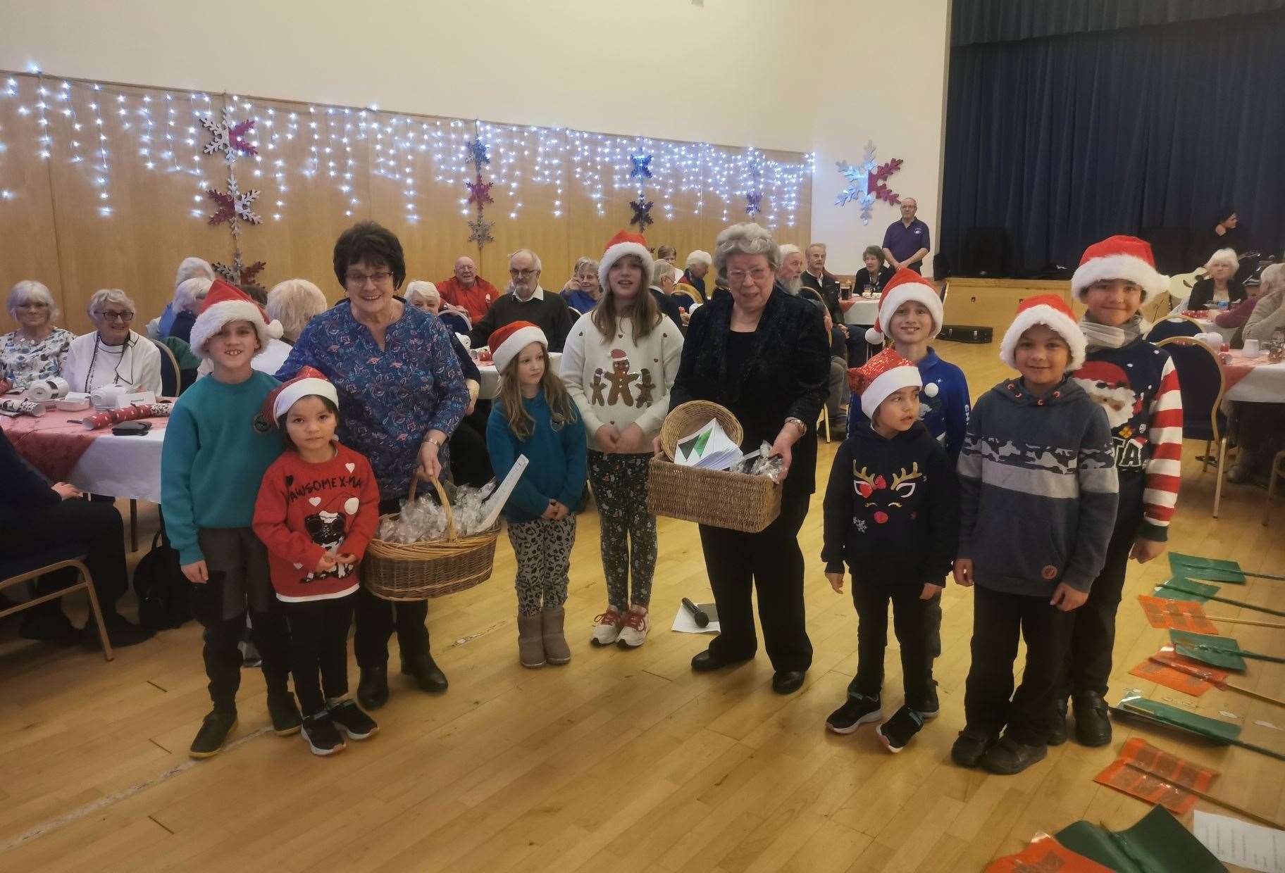The pupils from Crossroads Primary handed gifts to the Mey and District Senior Citizens Club after entertaining them with festive songs.