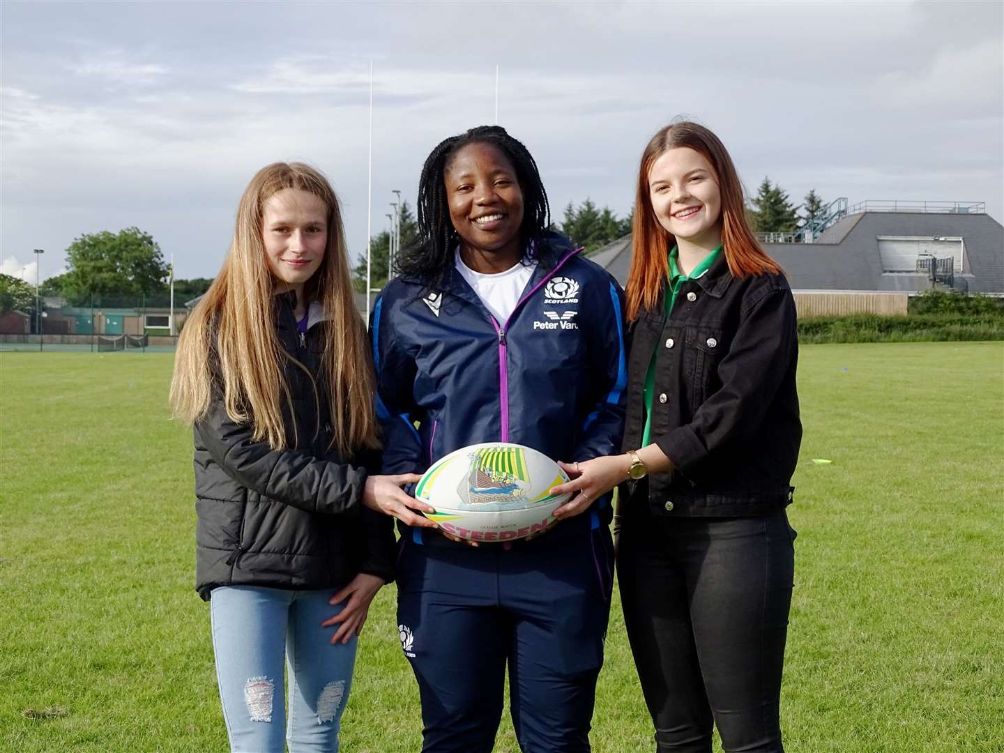 Scottish internationalist Panashe Muzambe is presented with a Caithness RFC rugby ball by Caithness juniors Tamzin Rosie and Rhianna Mackay. Picture: Anja Johnston