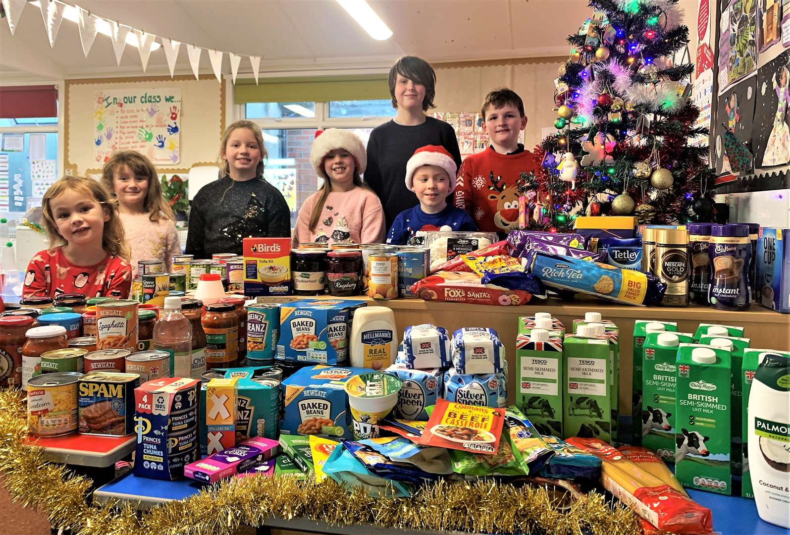 Thrumster Primary kids who are members of the FLAG committee with the donations received.