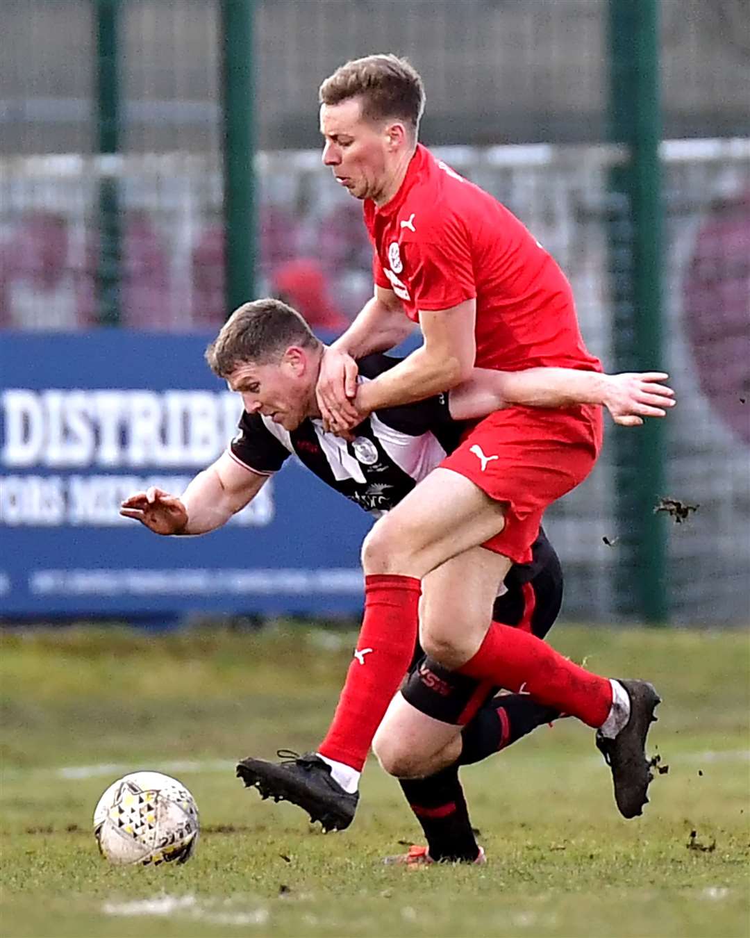 Wick Academy's Davie Allan is held down by Brora's Martin Maclean during the 2-2 draw at Dudgeon Park. Picture: Mel Roger