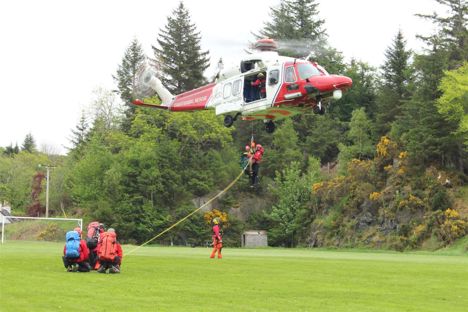 Members of the Assynt Mountain Rescue Team training with the HM Coastguard helicopter at Lochinver.