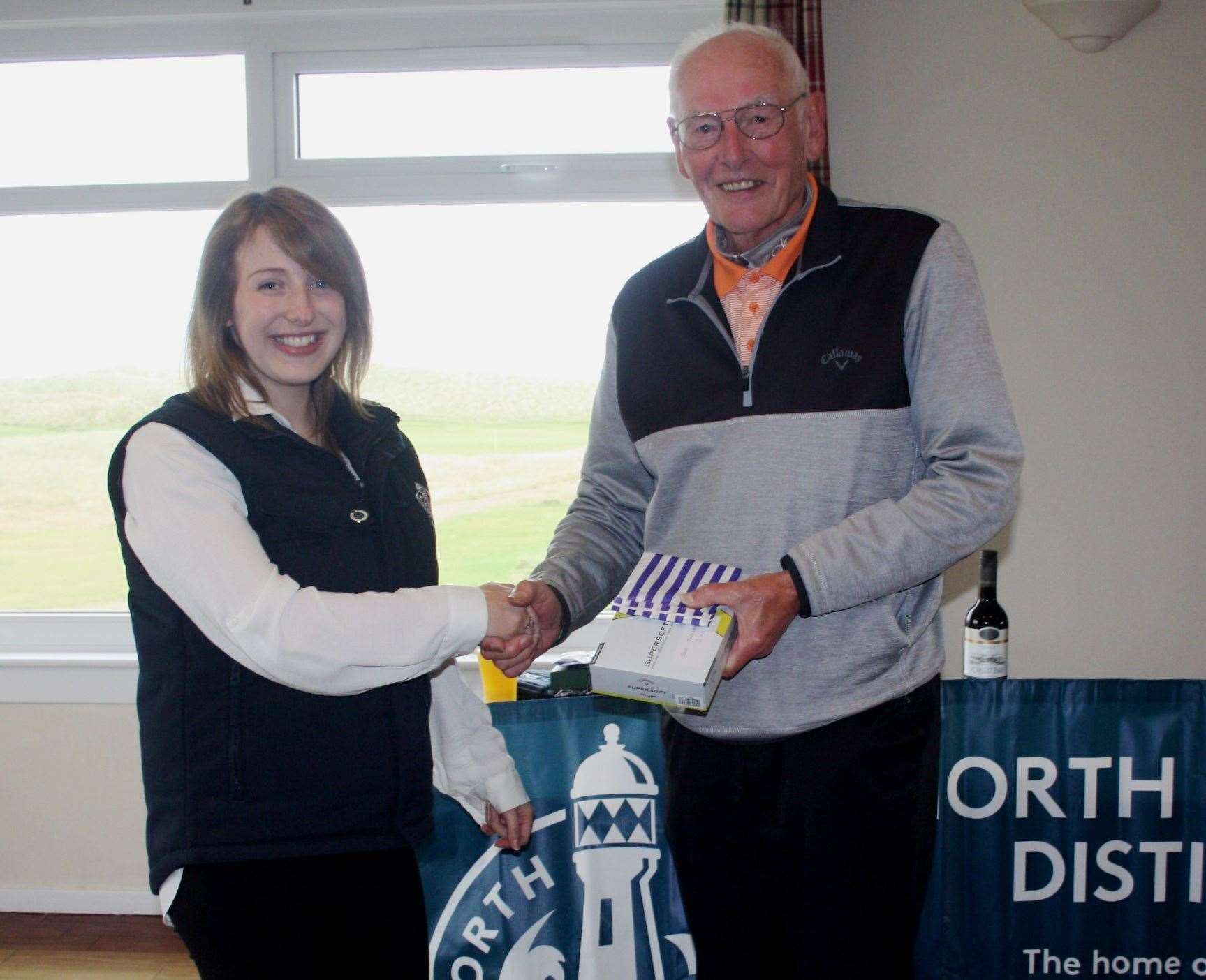Laura Pearce presents Jack Johnstone with the seniors' summer Stableford runner-up prize. The overall winner, John Brock, was unable to attend.