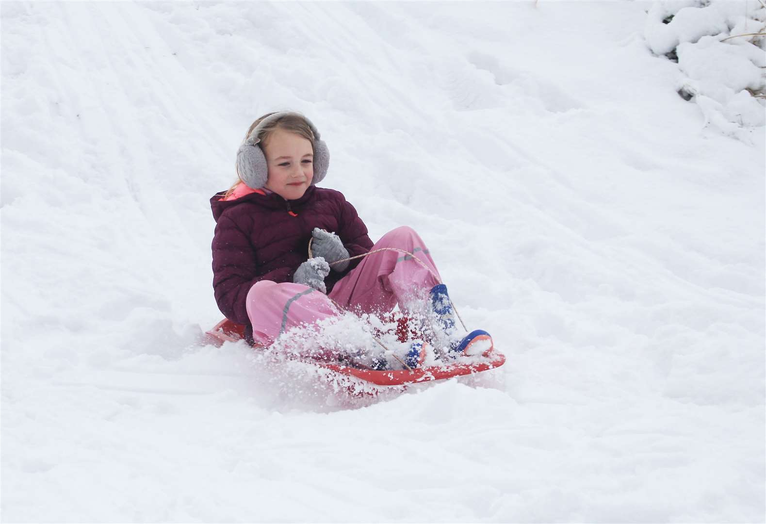 Seven-year-old Abbie Duncan sledging at the riverside. Picture: Alan Hendry