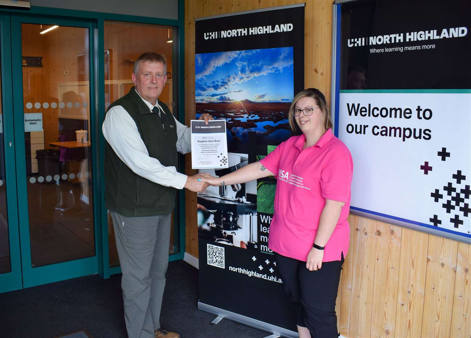 Robbie Rowantree, chairman of the UHI North Highland board of management, presenting the certificate to Sophie-Ann Bain.