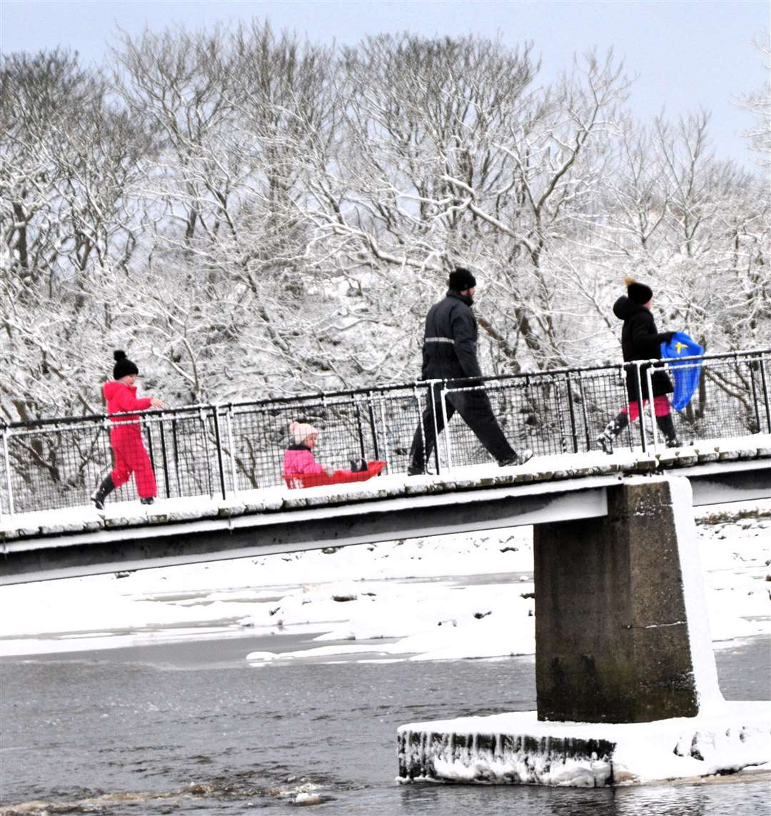 Children with sledges making their way over the Coghill footbridge in Wick. Picture: Noel Donaldson