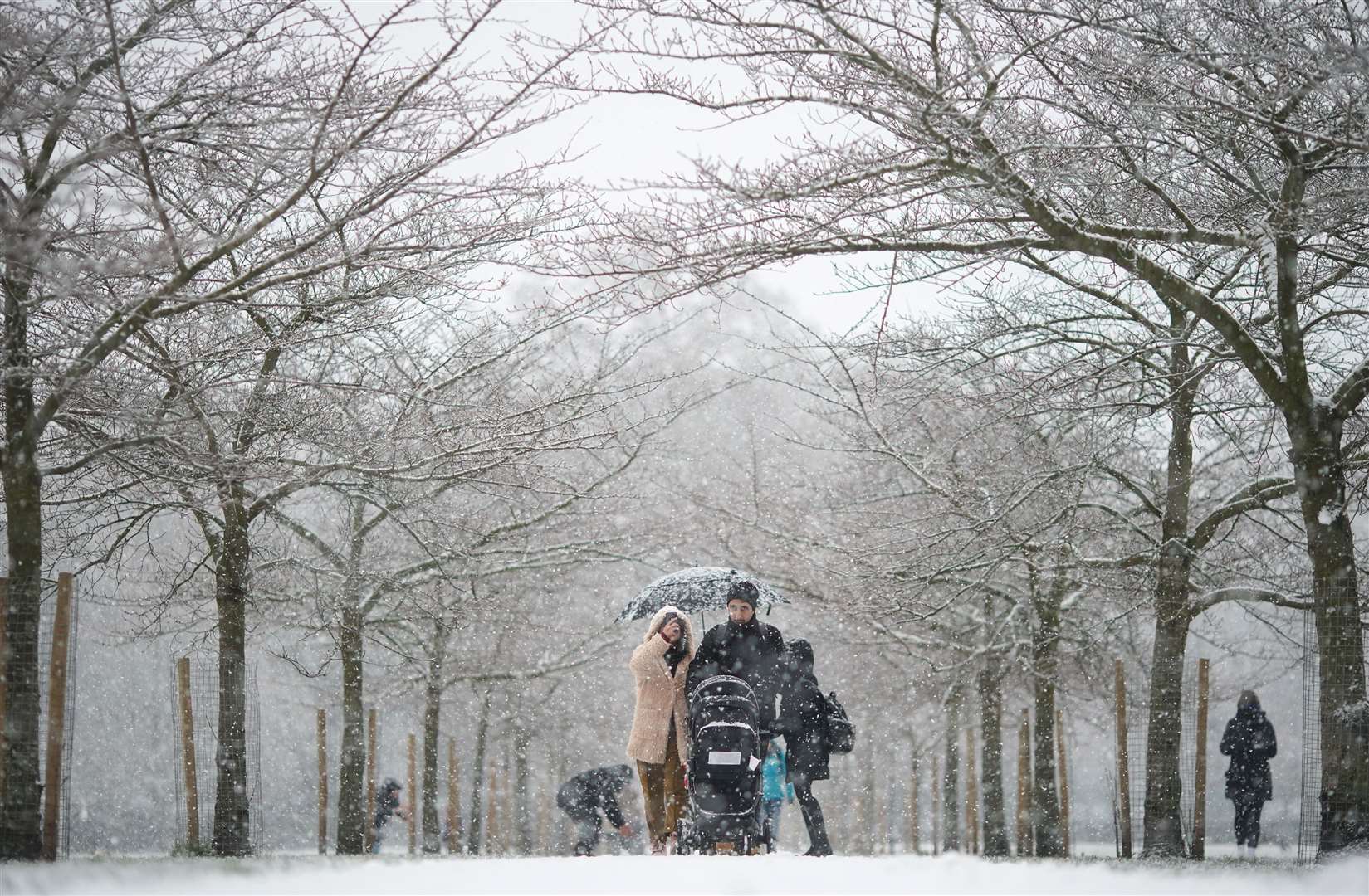 People walking in the snow in Battersea Park, London (Aaron Chown/PA)