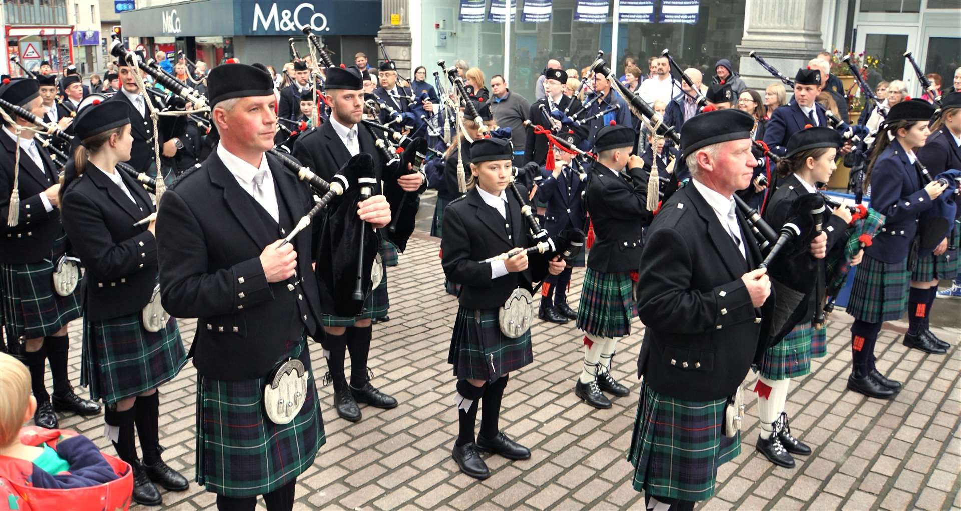 The massed pipe band event was squeezed out of Market Square by parked cars on Saturday evening. Pictures: DGS