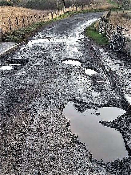 Photos from the road at Ham taken in November 2021 showing how badly potholed it is. Picture: CRR