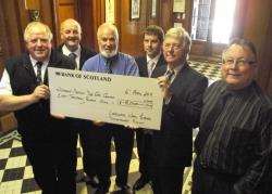 John Gunn and Danny Dickson receive the cheque for £8000 from Councillor Robert Coghill while councillors Willie Mackay, David Bremner and David Flear look on.