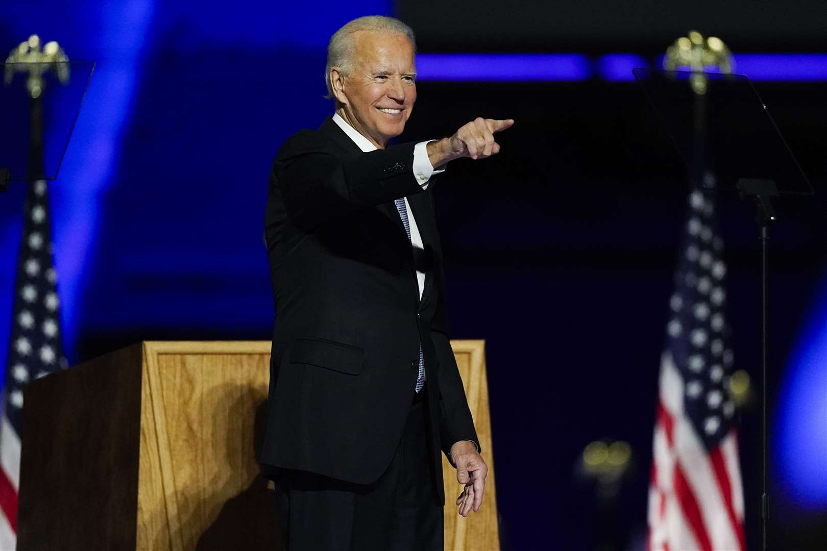 President-elect Joe Biden points to the crowd as he stands on stage after speaking (Andrew Harnik/AP)