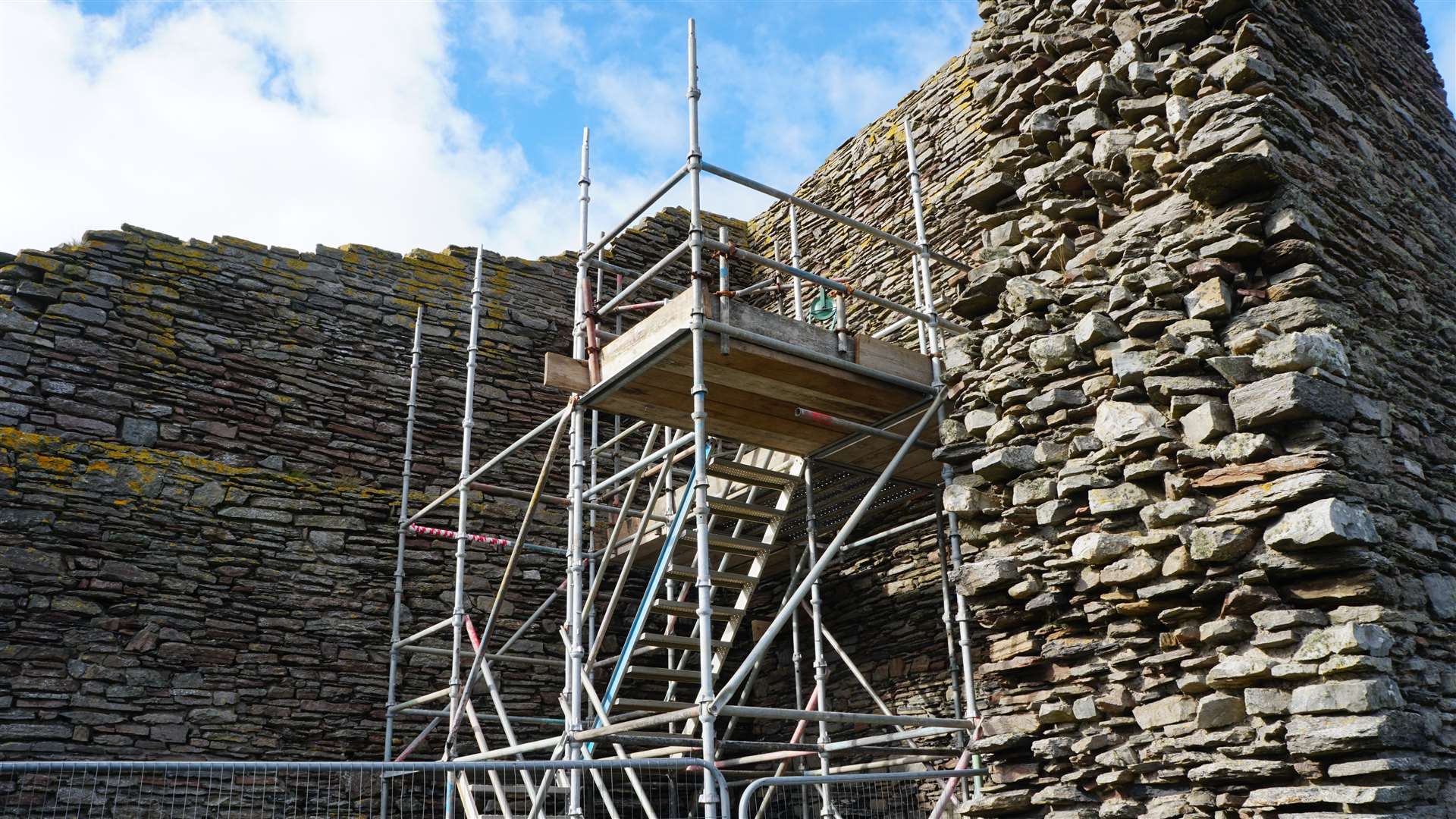 Work being carried out last year to remove the piece of timber from a slot high up in a wall of the castle. Picture: DGS