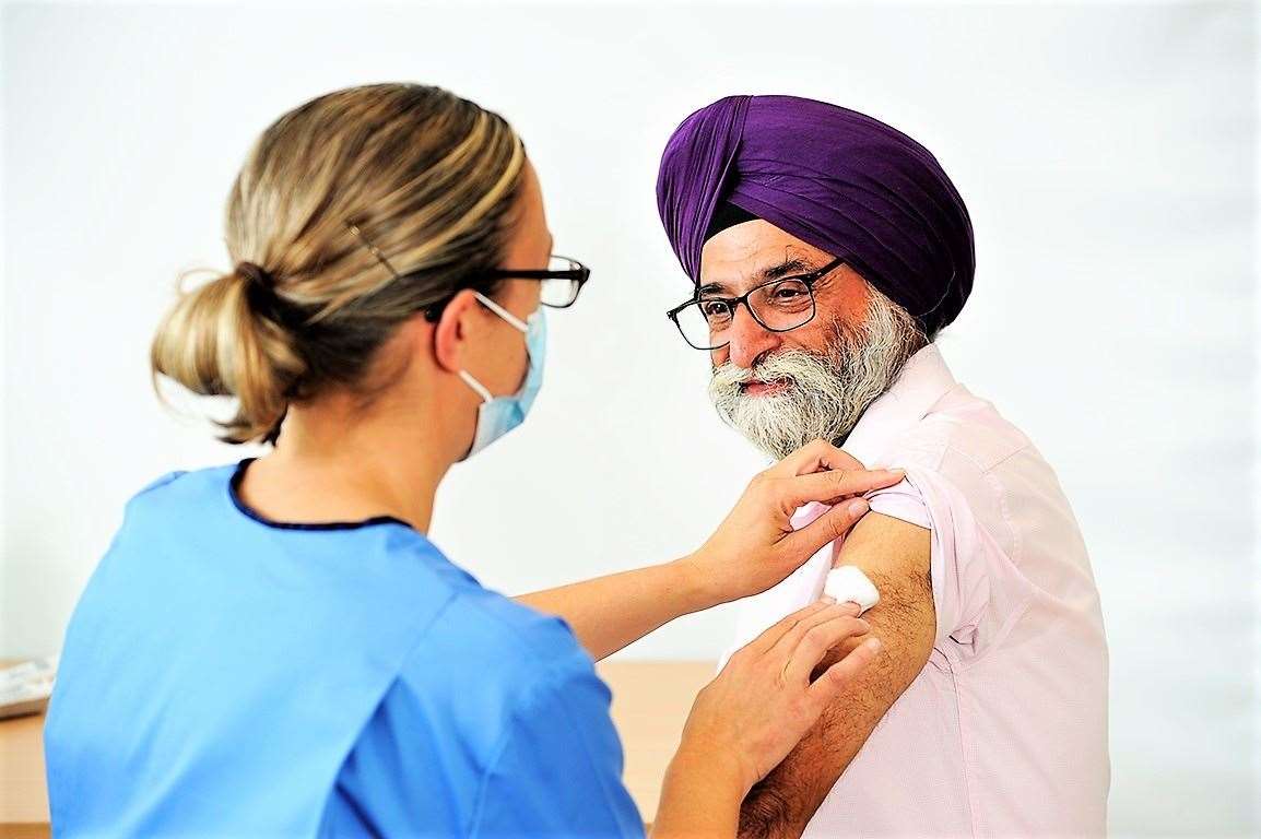 A Sikh man being given the flu vaccine.