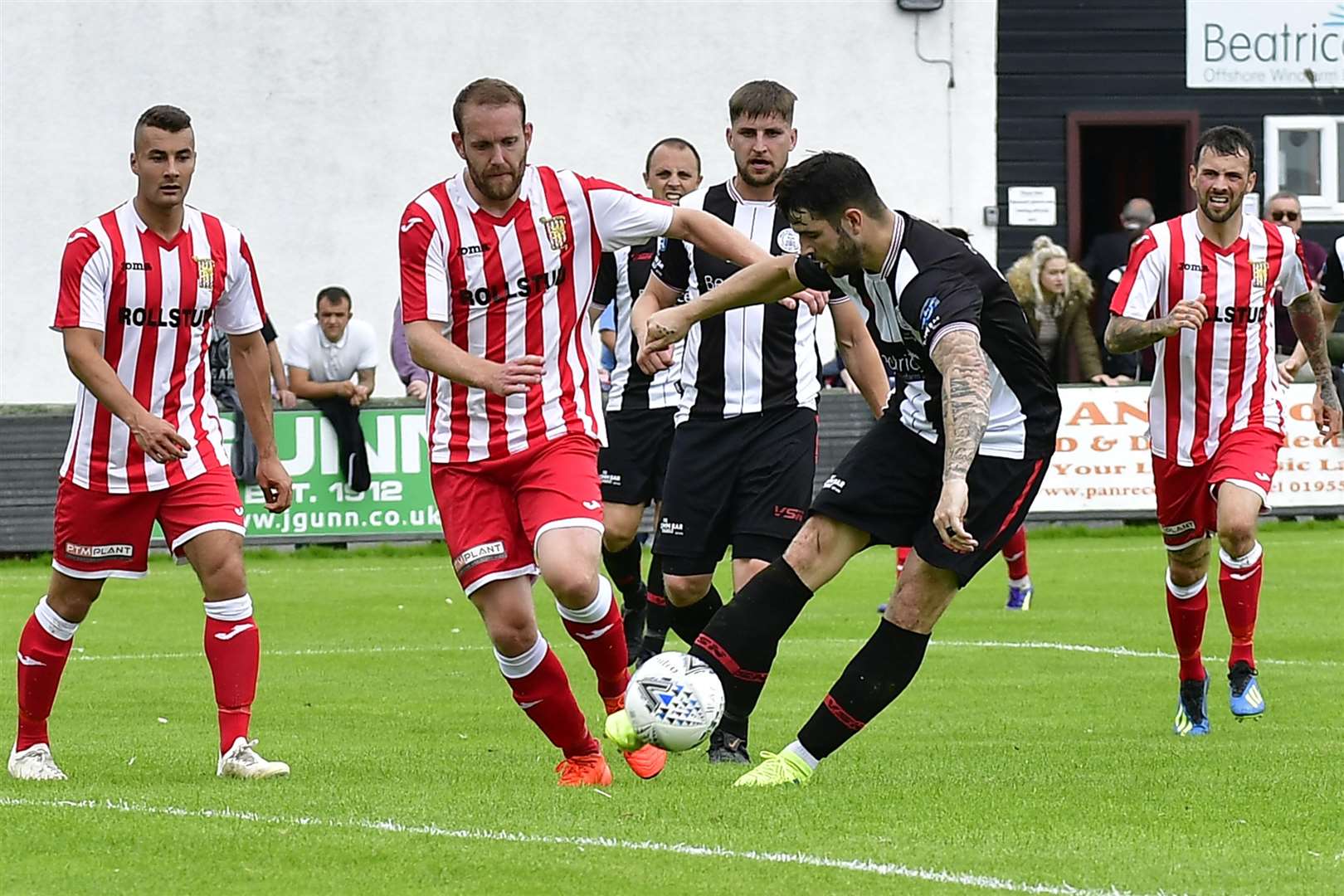 Sam Mackay hooks the ball away from Formartine's Garry Wood. Picture: Mel Roger