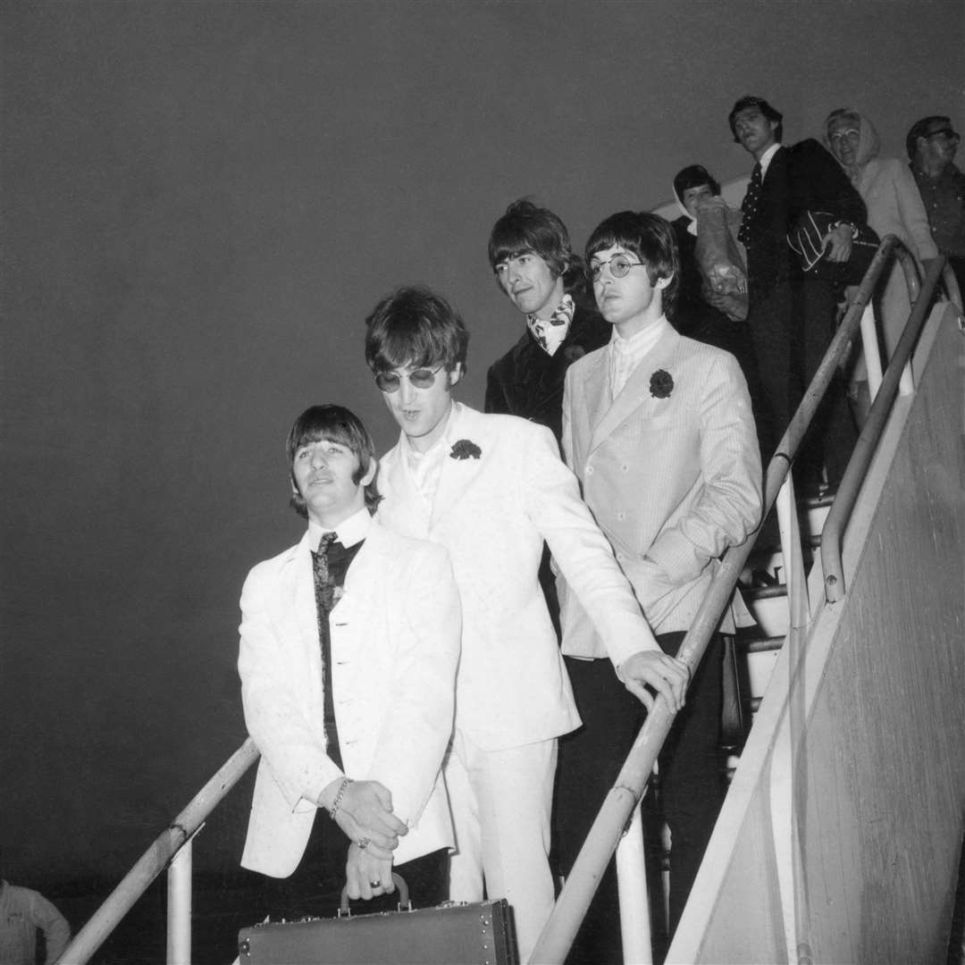 The Beatles pictured as they arrive back in London after going on tour (PA)