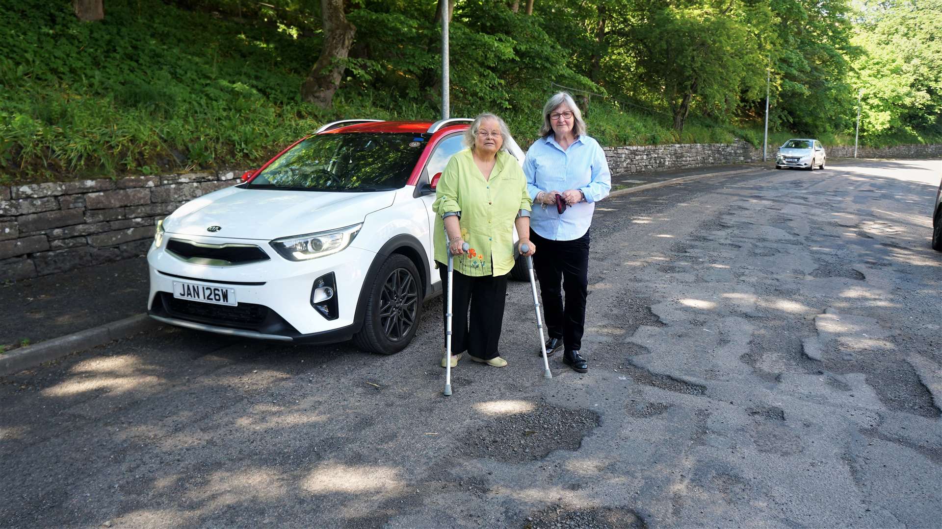 Helen Budge, left, with her friend Jan McEwan surrounded by potholes on Union Street in Wick. Picture: DGS