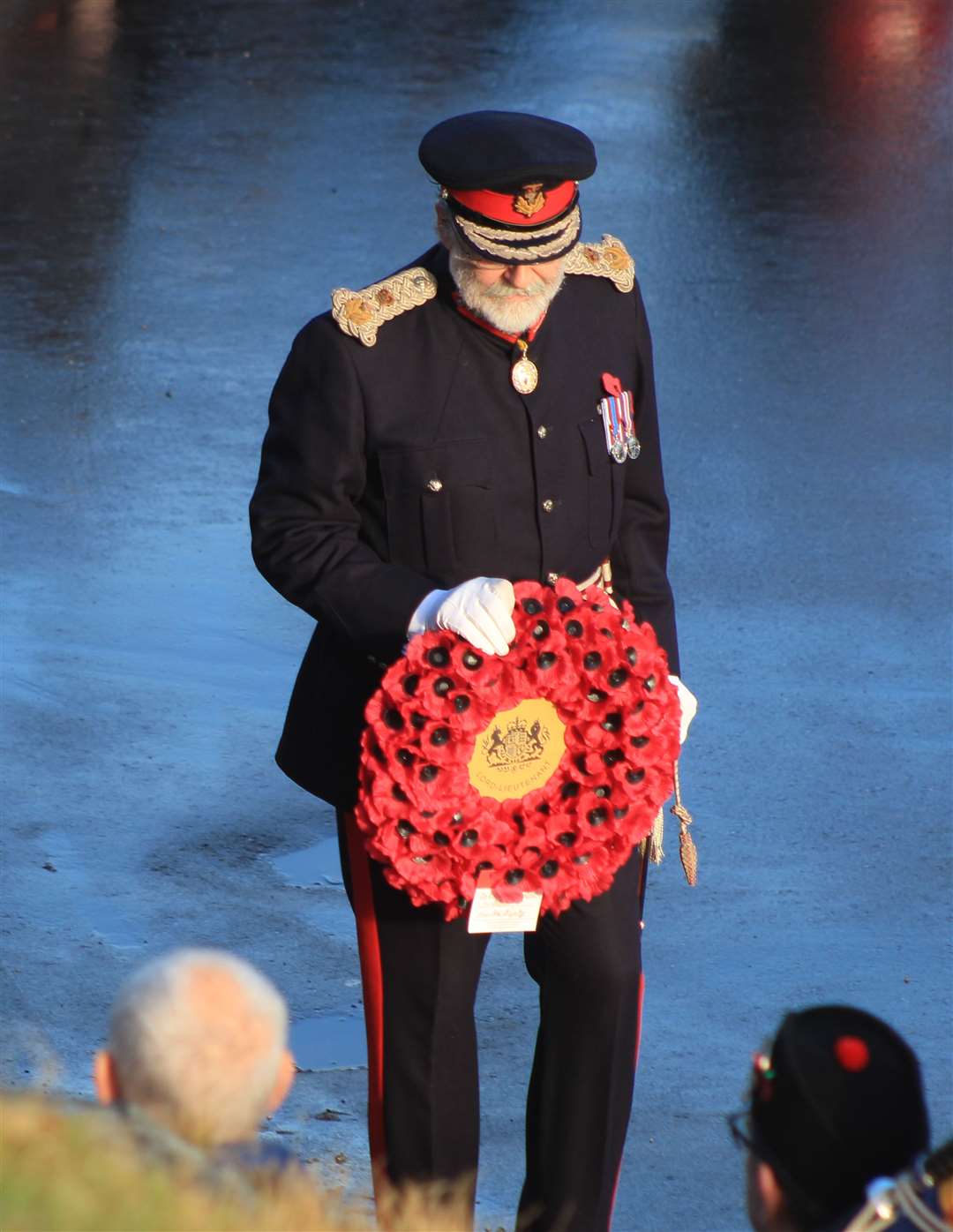 Lord Thurso stepping forward to lay the first wreath at Wick. Picture: Alan Hendry