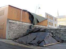 The roof of the old police station in Victoria Place, Wick, was ripped off early on Sunday morning. Two cars were trapped underneath the roof material. Photo: Will Clark.