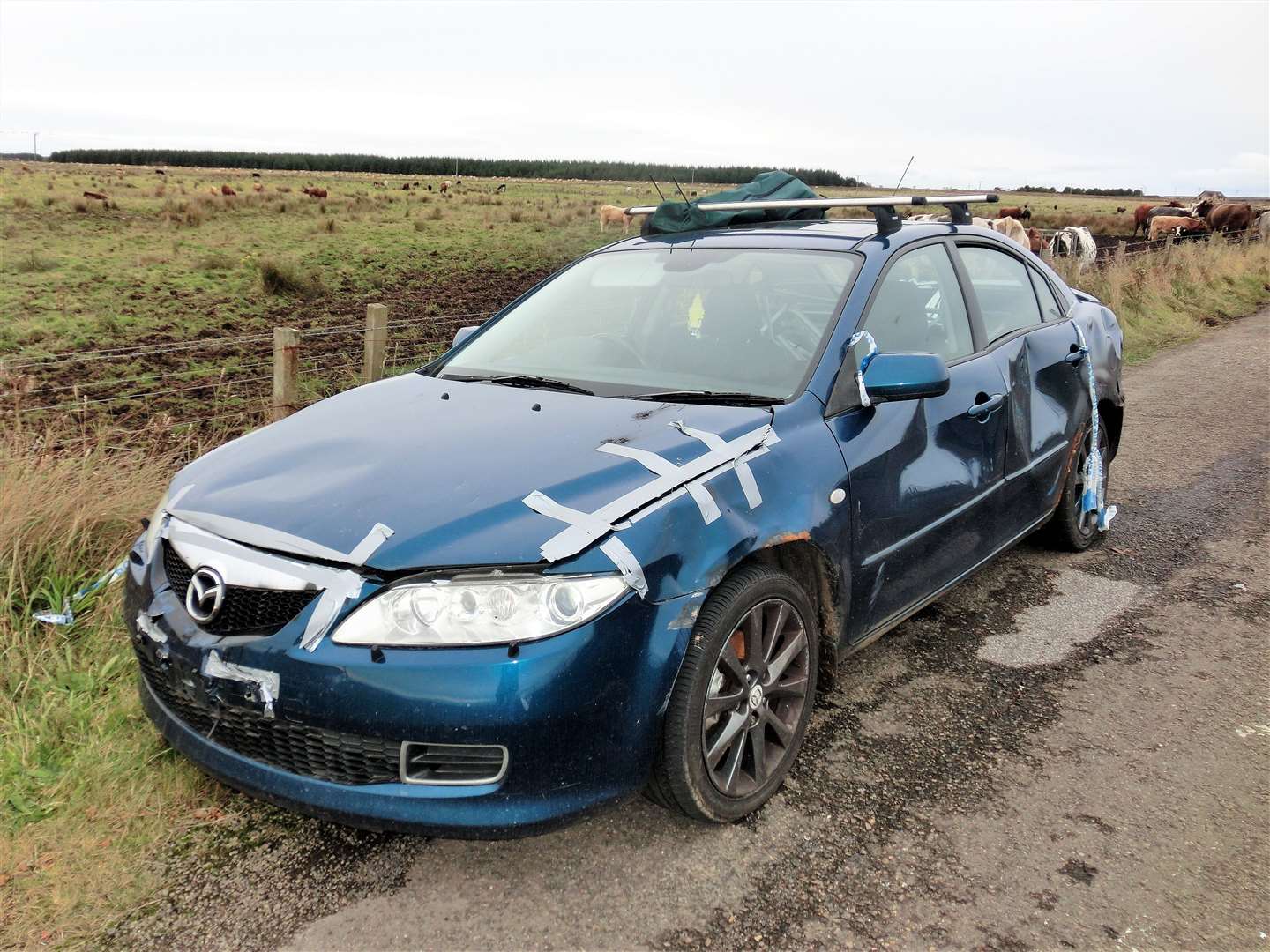 The blue Mazda left abandoned at the side of the road near Keiss shows signs of damage. Picture: DGS.