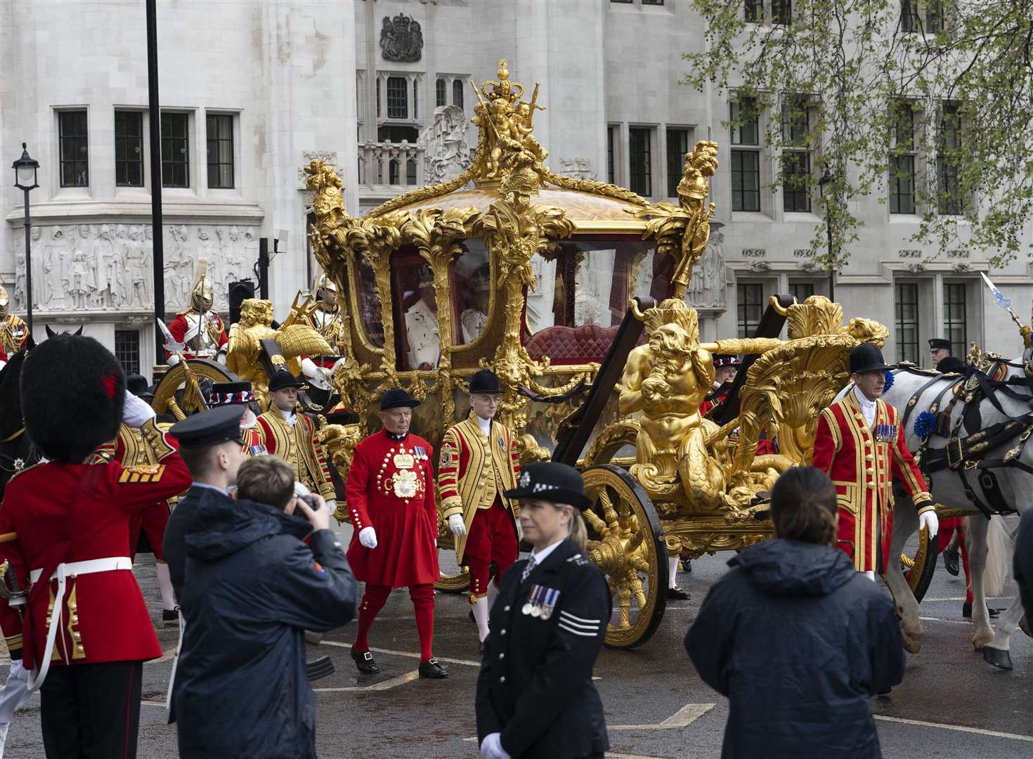 The King and Queen are carried in the Gold State Coach, pulled by eight Windsor Greys, as they leave Westminster Abbey (David Rose/The Telegraph/PA)