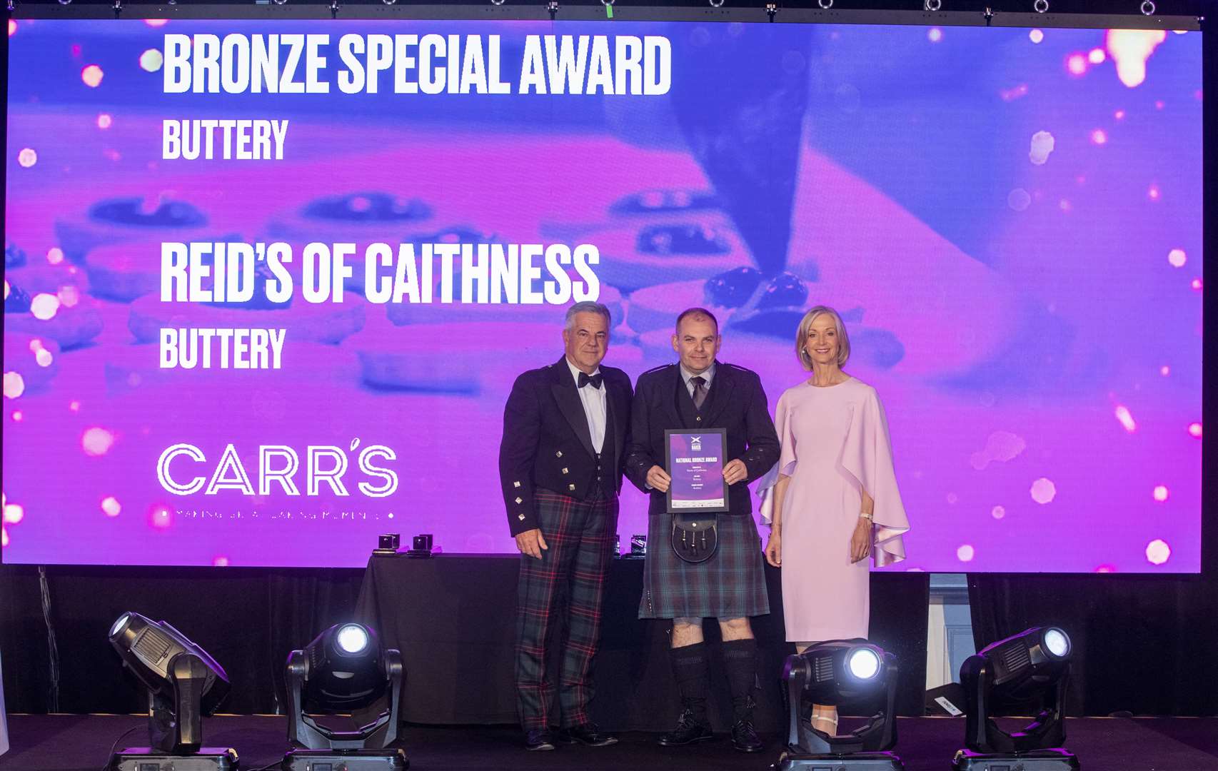 Gary Reid (centre) receiving the bronze special award in the buttery category, alongside Alan Burns of Carrs Flour and competition host and industry specialist Mich Turner MBE.