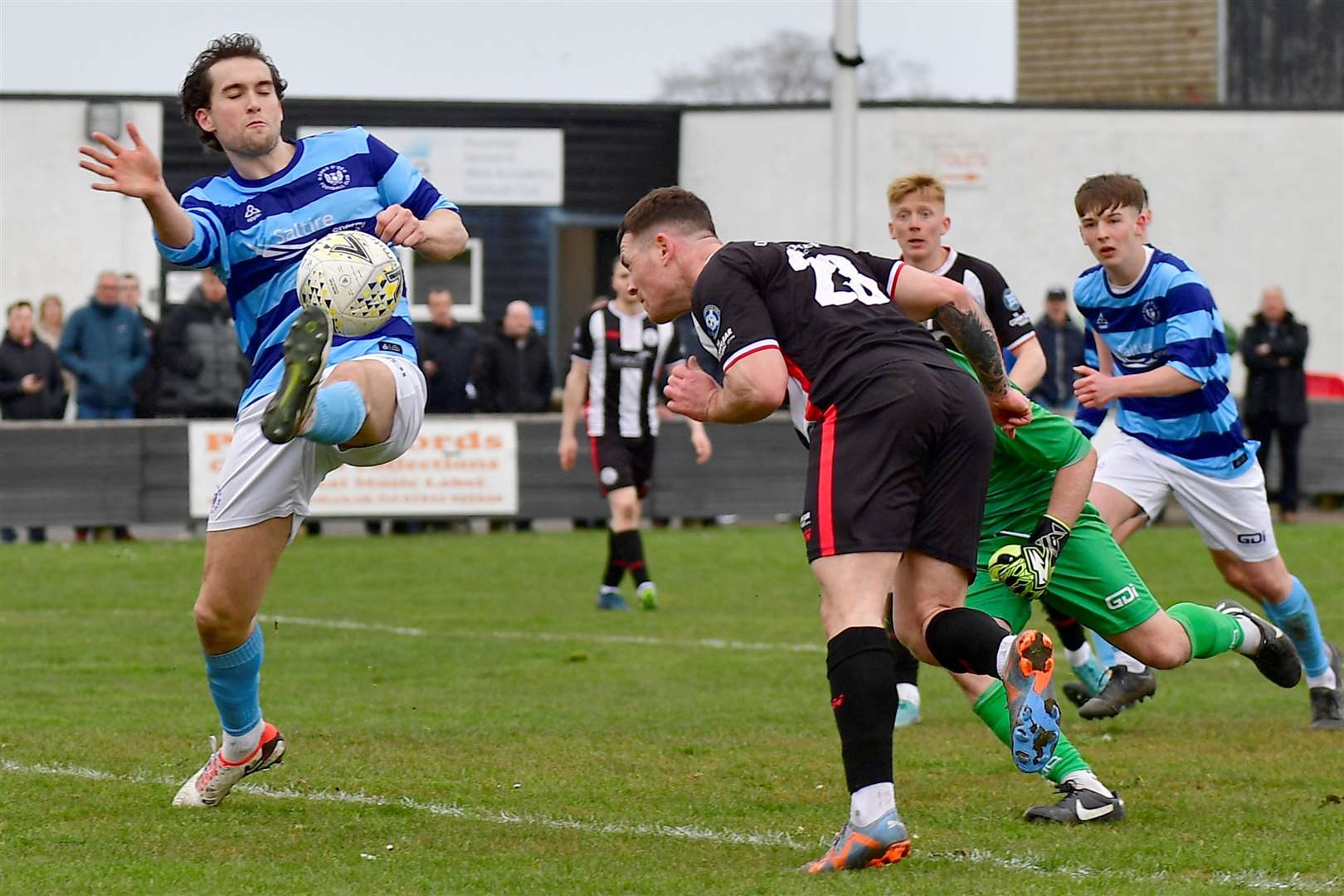 Gordon MacNab directs his header past the outstretched leg of Jevan Anderson for Wick Academy's equaliser. Picture: Mel Roger