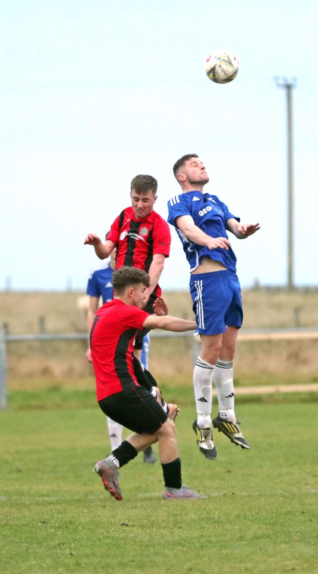 Halkirk United's Grant Aitkenhead competes for a header with Ruaridh Patience of Invergordon. Picture: James Gunn