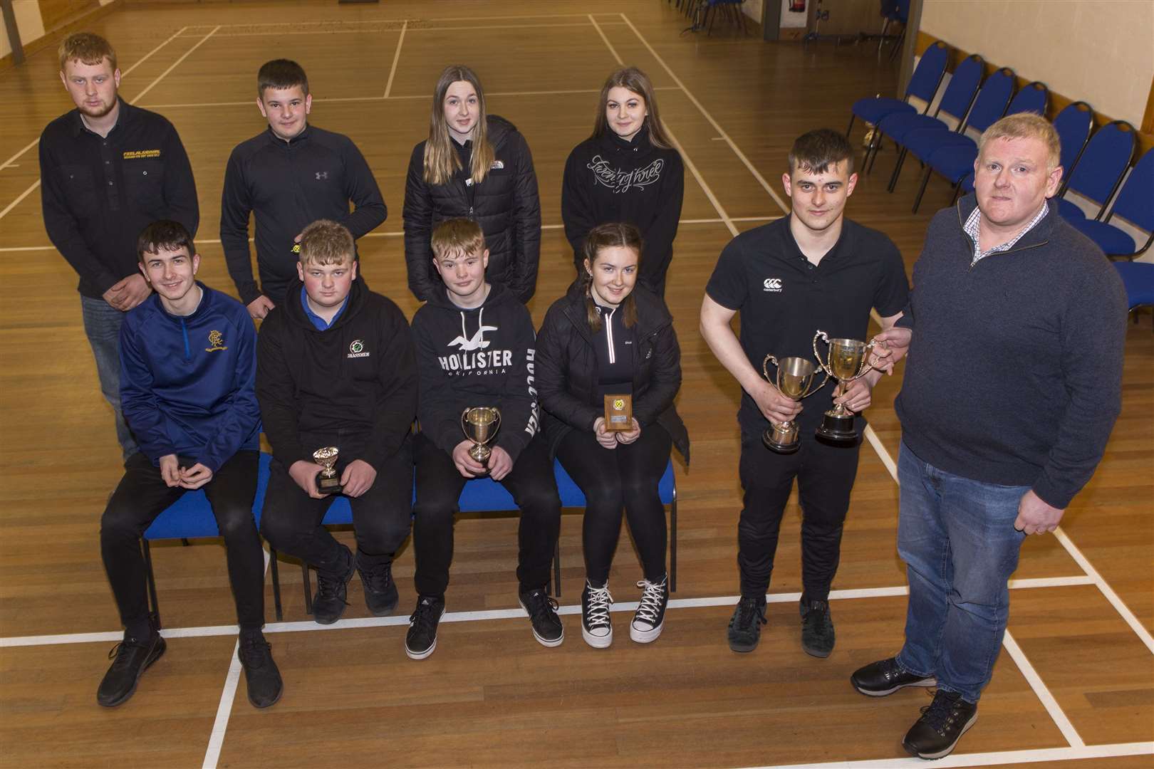 Halkirk's Robbie Levack won the Caithness Small Bore Rifle Association annual indoor junior championship, held in Lieurary hall. Robbie – pictured receiving his trophy from association chairman Graham Mackay – also won the junior individual league Division One. Looking on are other junior shooters who took part in the championship. Front (from left): Ross Sutherland, Halkirk; Luke Taylor, Westfield, who also won the Division Two individual title; John Bremner, who won the county open handicap championship; and Sophie Campbell, runner-up to the junior champion, both Halkirk. Back: Jake Taylor, Cameron Mackay, both Westfield; Grace Campbell, Halkirk; and Iona Simpson, Wick Old Stagers. Picture: Robert MacDonald / Northern Studios