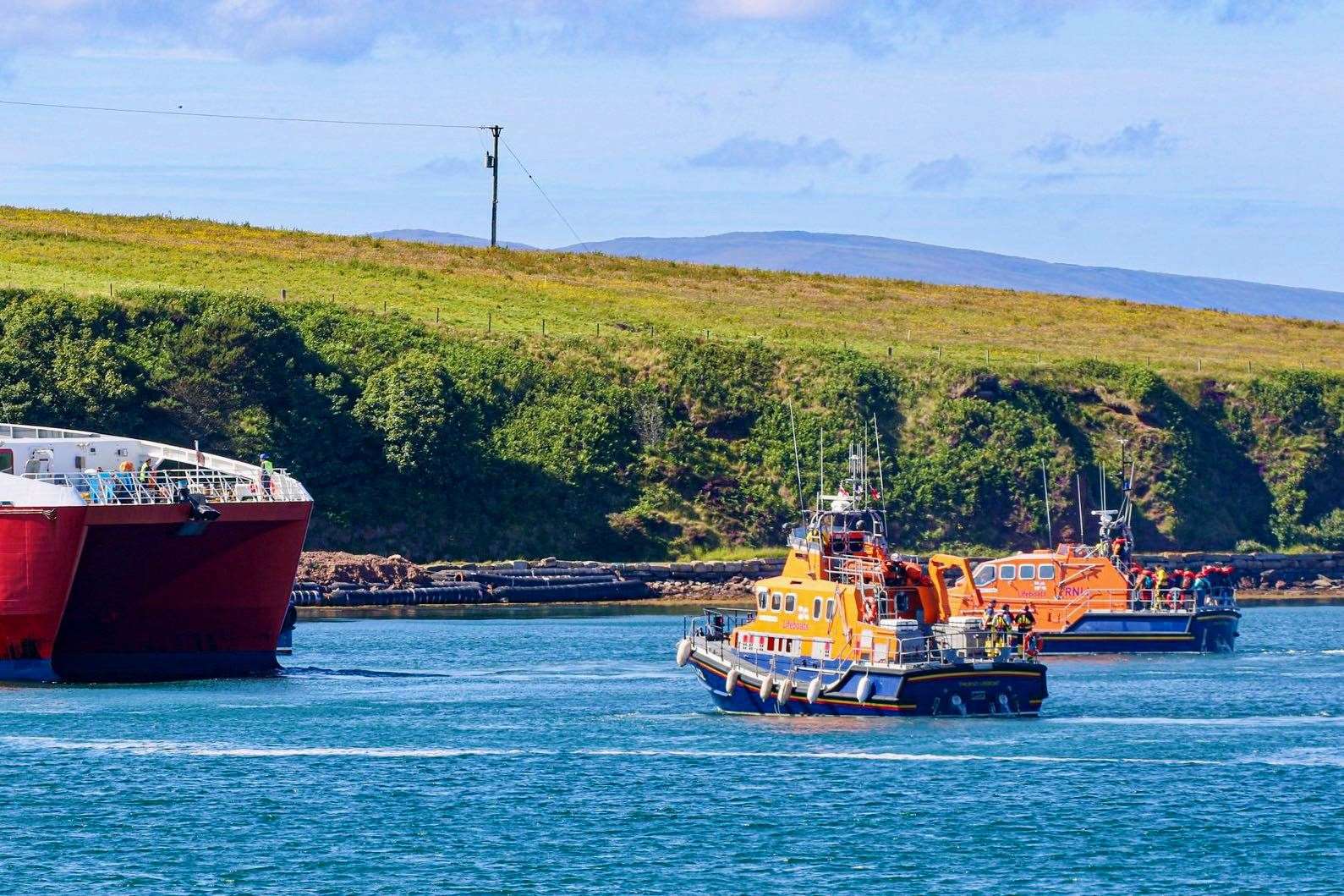 The two lifeboats alongside the MV Alfred at St Margaret's Hope. Picture: Graham Campbell / Longhope RNLI