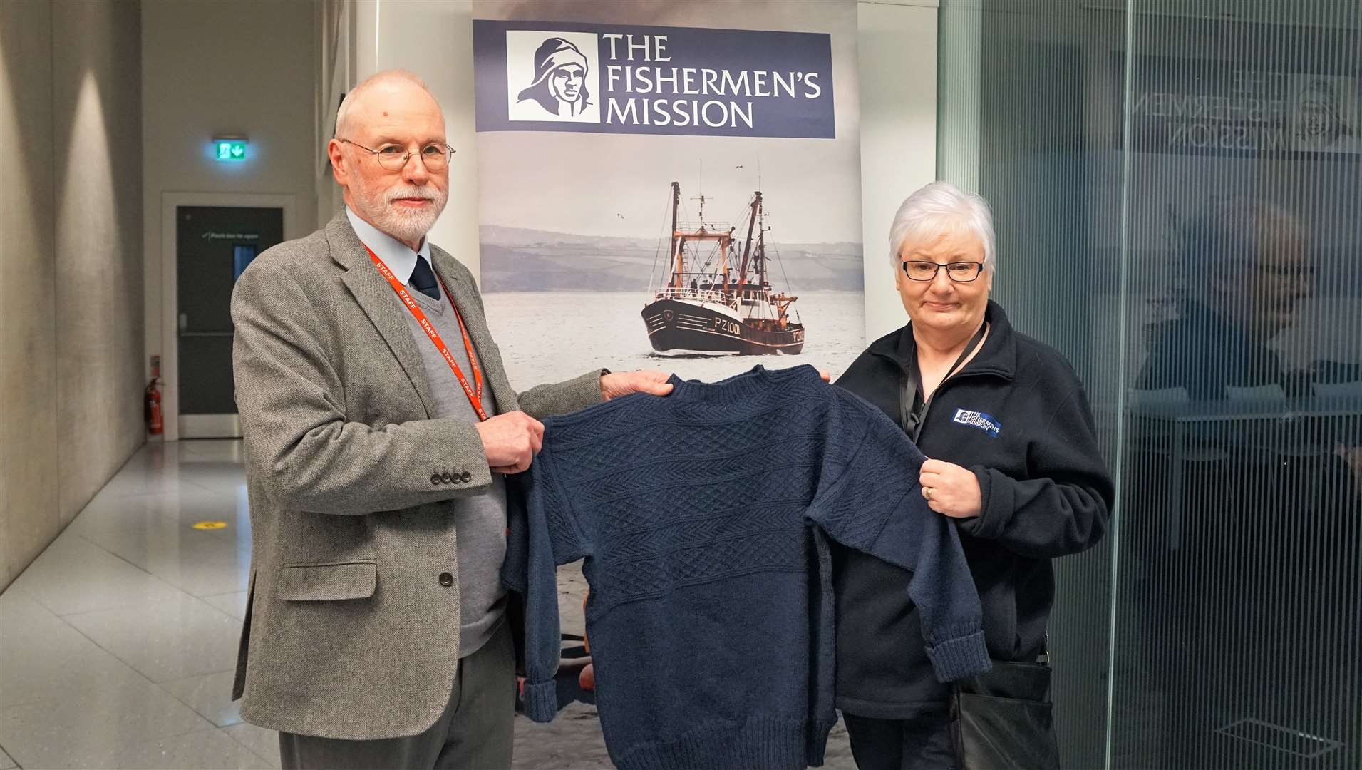 The gansey was knitted by Gordon Reid who is pictured at Nucleus archive centre in Wick where he works. Alongside him is Jackie Dodds from the Fishermen's Mission. Picture: DGS