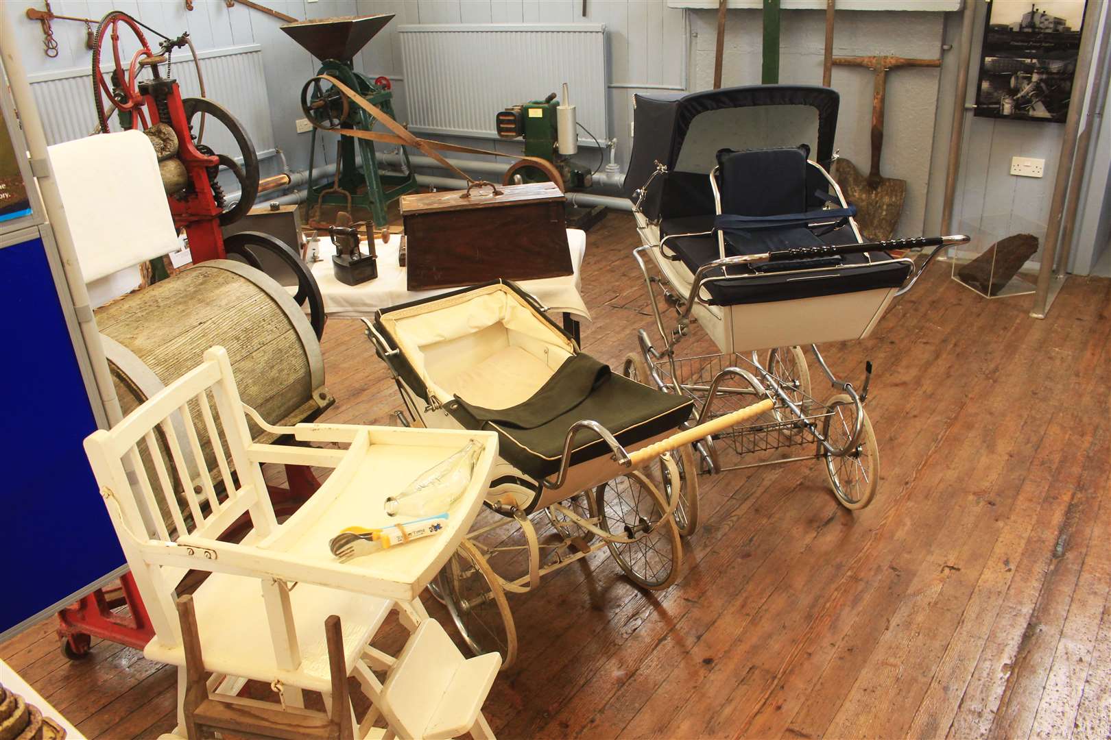 Prams and a baby's high chair within one of the display areas.