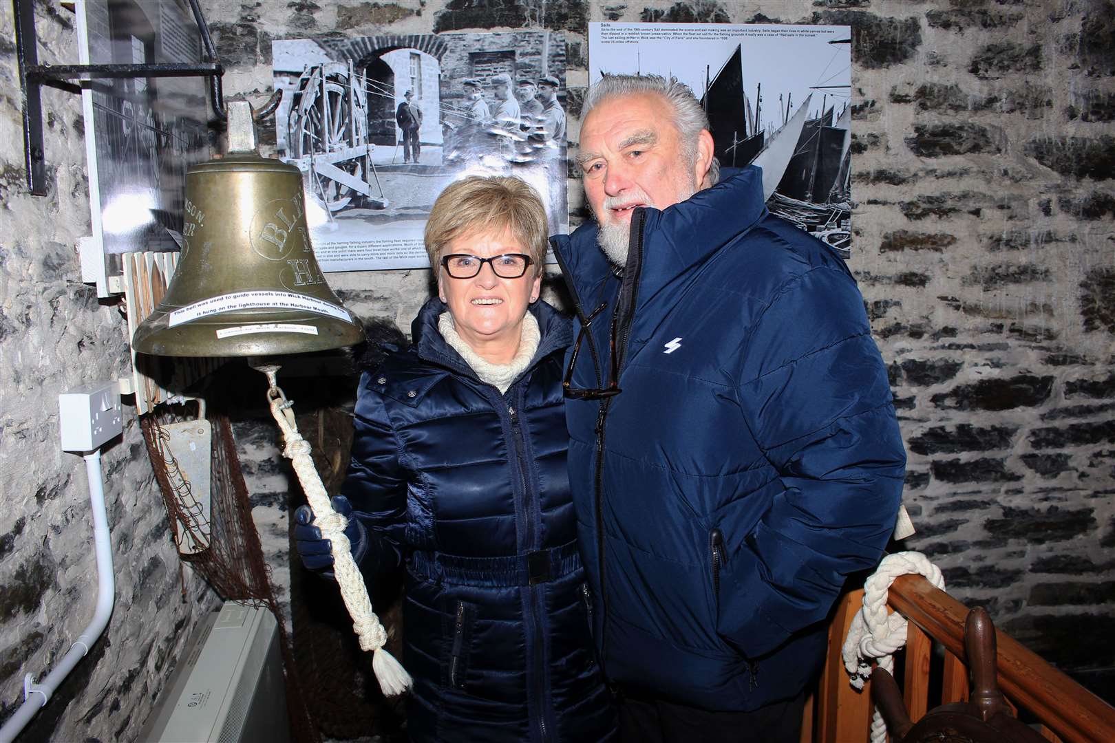 Linda and Geordie Robertson from Keiss beside the bell in the museum's fishing hall. Picture: Alan Hendry