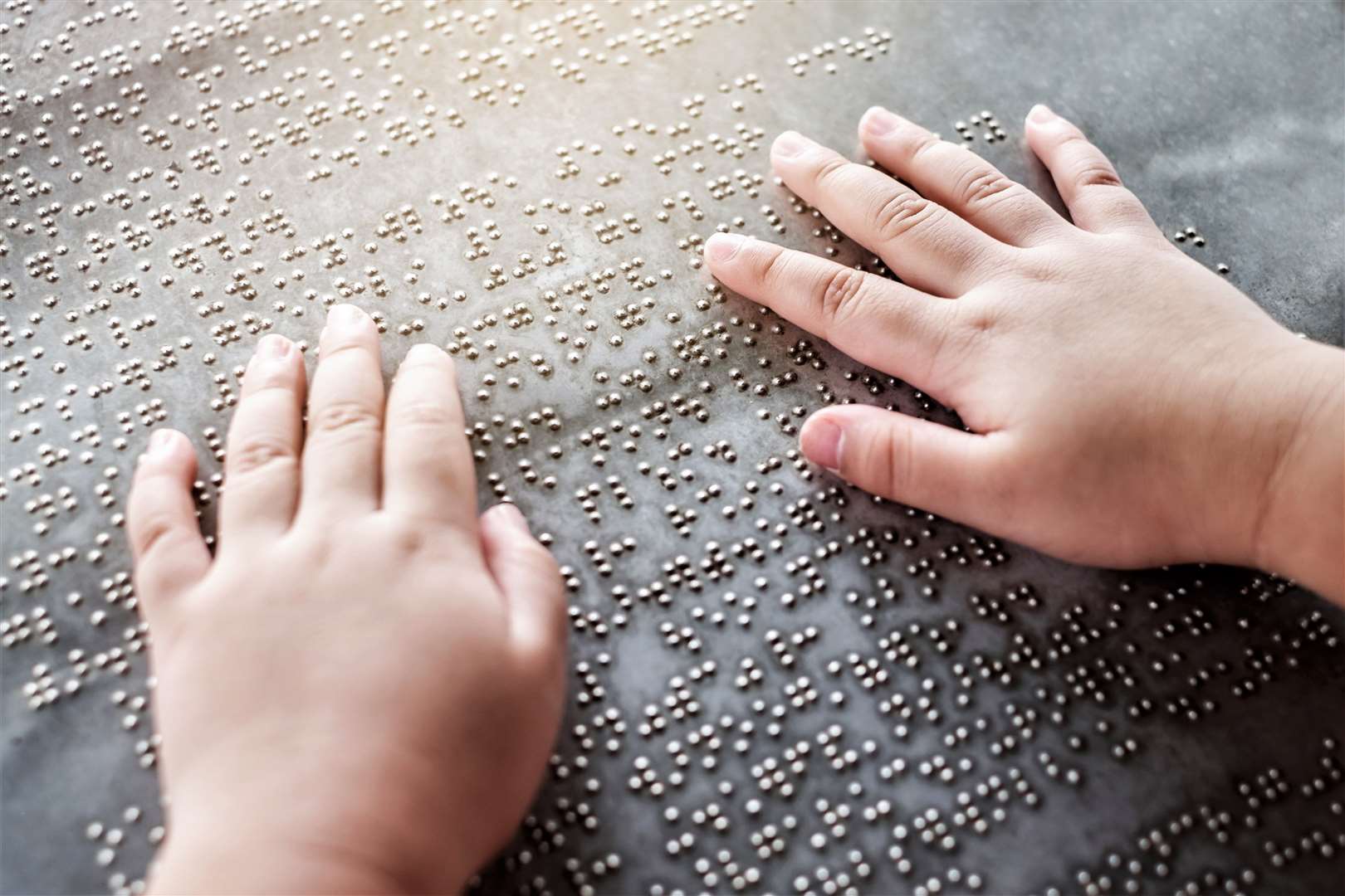 Blind child learns braille.