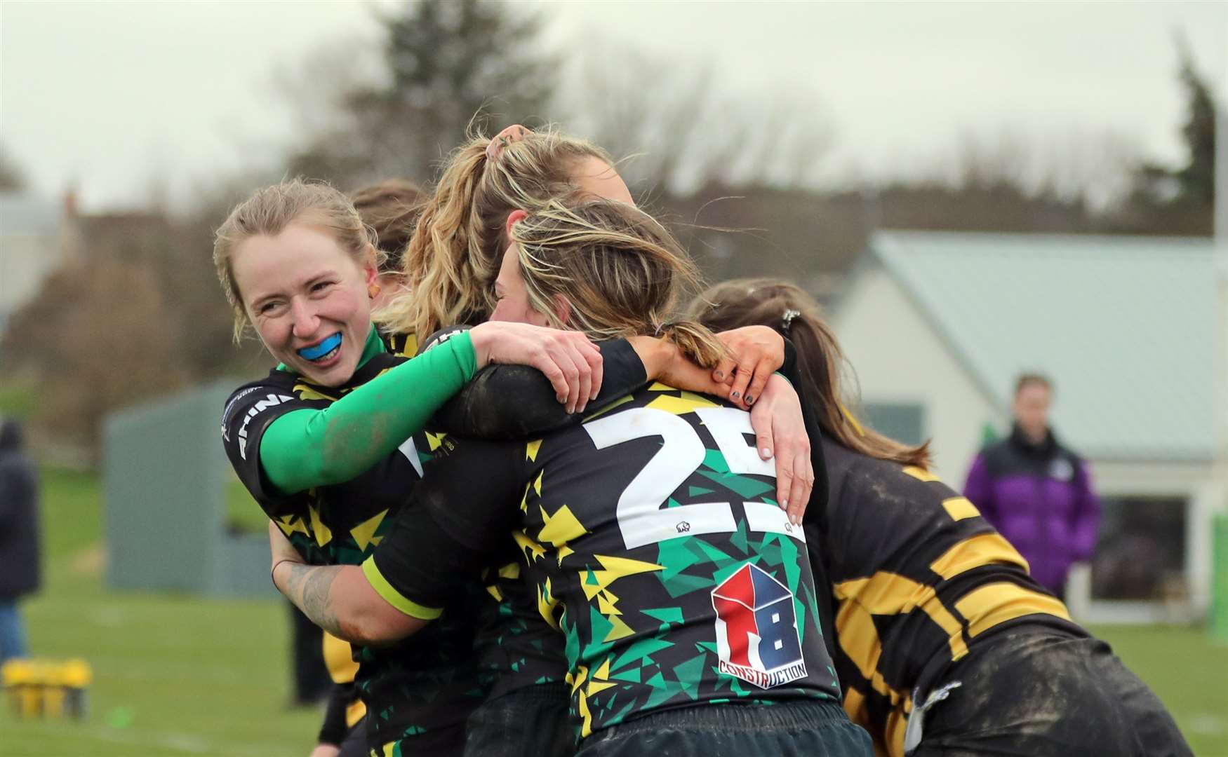 Emily Flavell is congratulated by Caitlin Flavell (left) and Emmy Smith after scoring a try. Picture: James Gunn