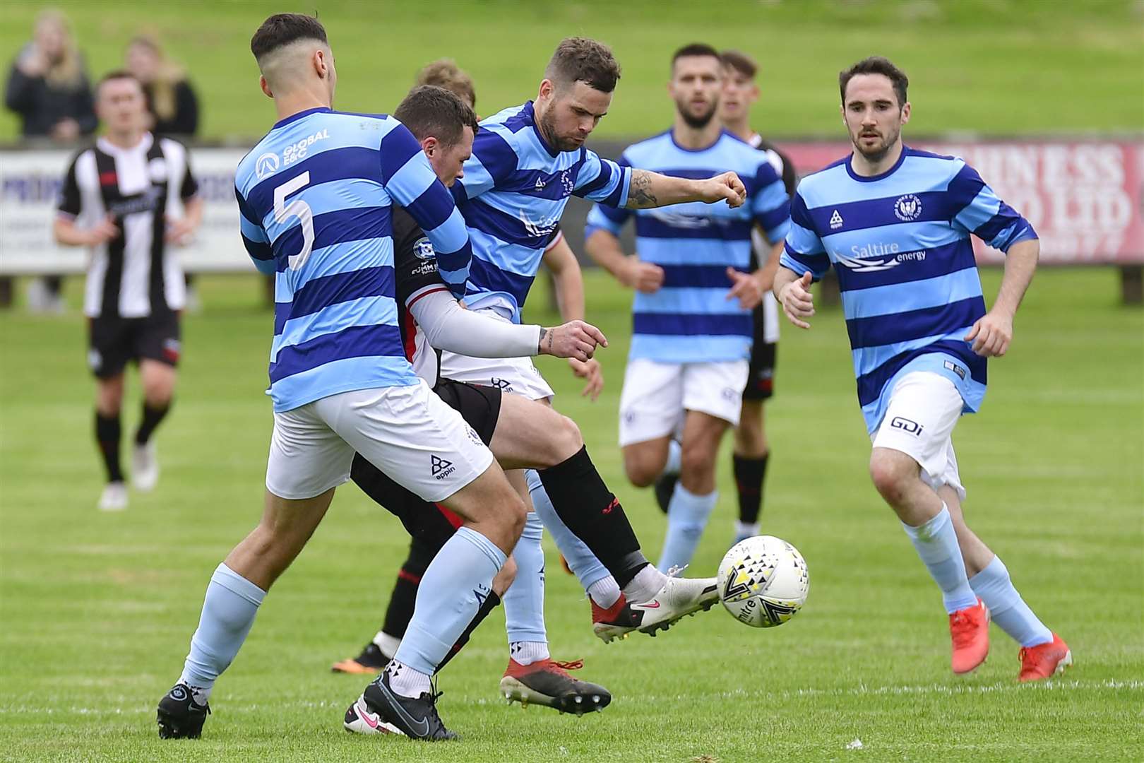Wick Academy's Gordon MacNab finds himself outnumbered by Banks O' Dee players. Picture: Mel Roger