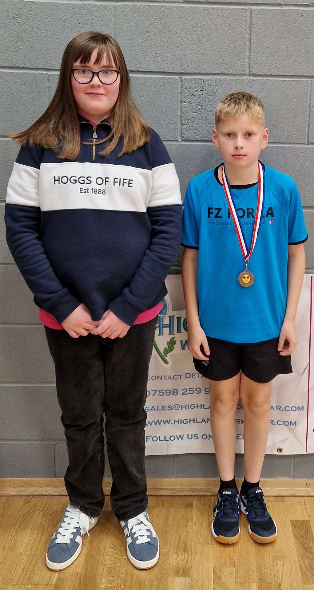 Lexie Mackenzie, representing Highland Workwear, with the boys' singles consolation winner Liam Sinclair.