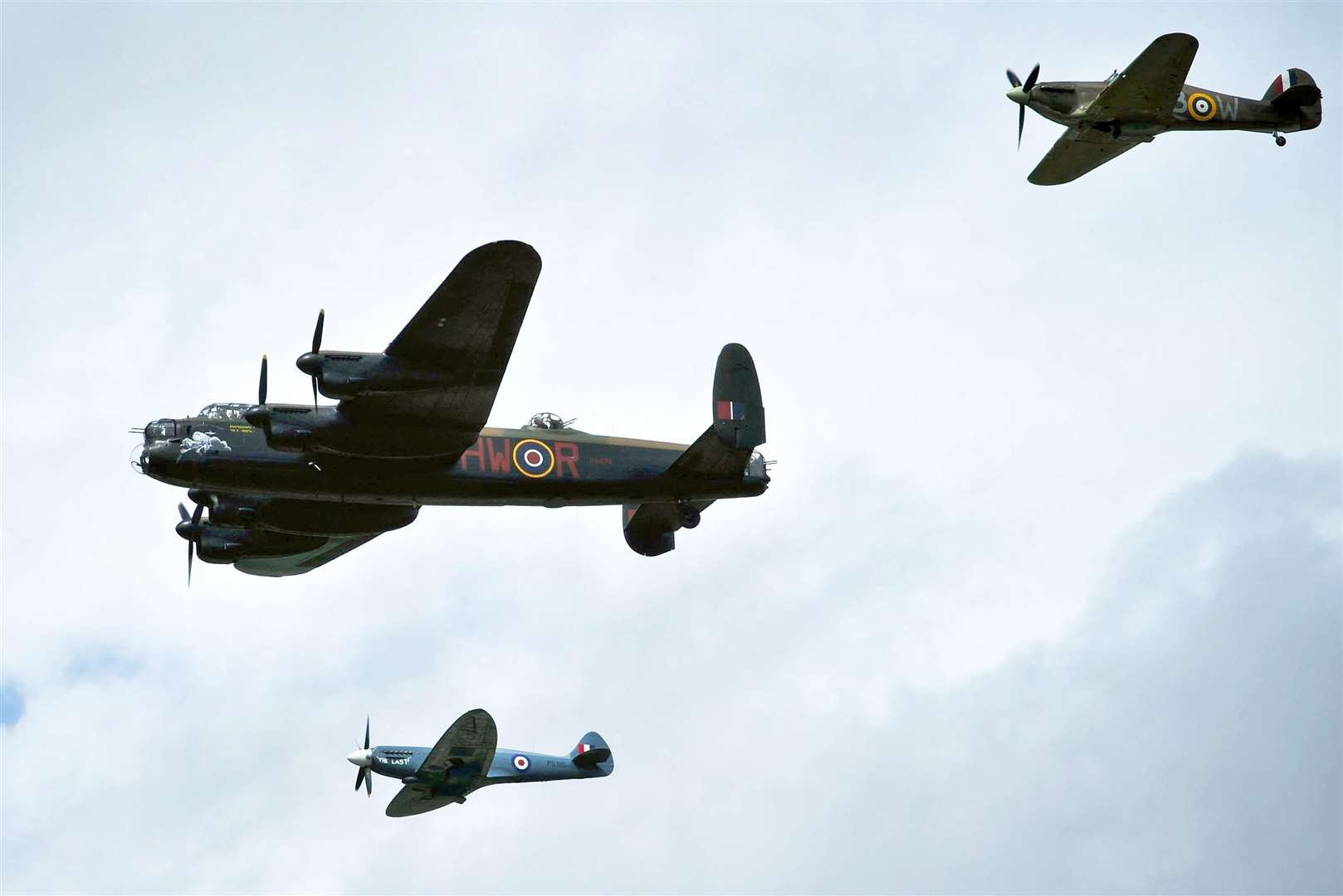 The Hawker Hurricane, top right, alongside the Avro Lancaster, centre, and Supermarine Spitfire, forms the RAF Battle of Britain Memorial Flight (Ben Birchall/PA)