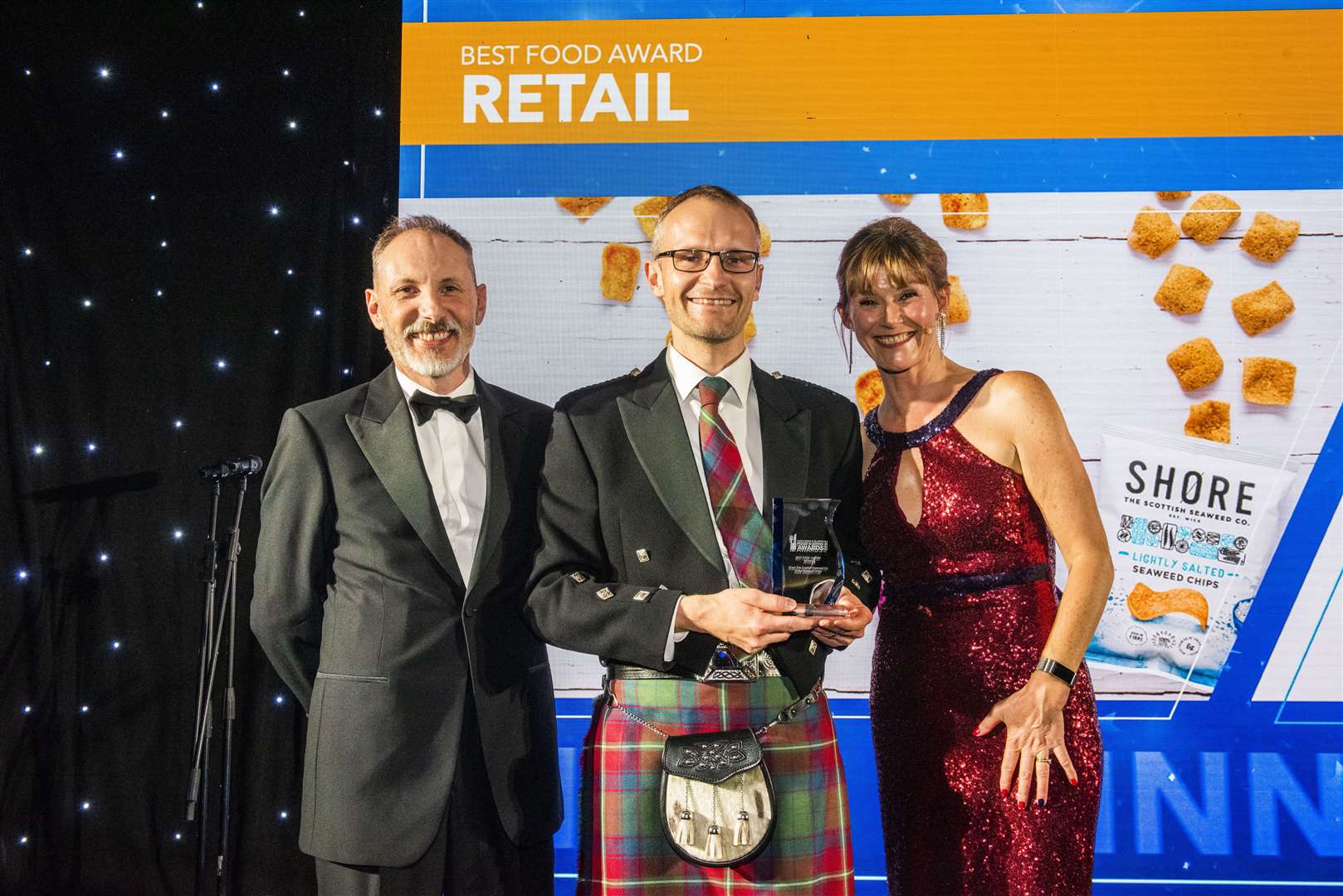 Peter Elbourne of Shore seaweed company after receiving the award from Douglas Hardie, with host Nicky Marr looking on. Picture: Chris Watt Photography