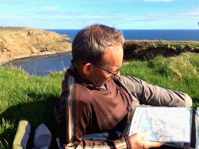 Rob studies his map while taking a break on the John O'Groats Trail.