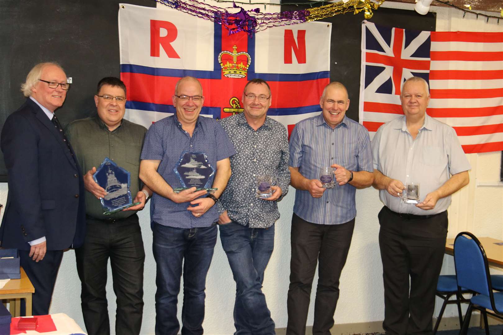 Receiving their awards from Wick RNLI management committee chairman Murray Lamont (left) are Graham Cormack, Mark Cormack, Colin Campbell, Graeme Campbell and John Taylor.