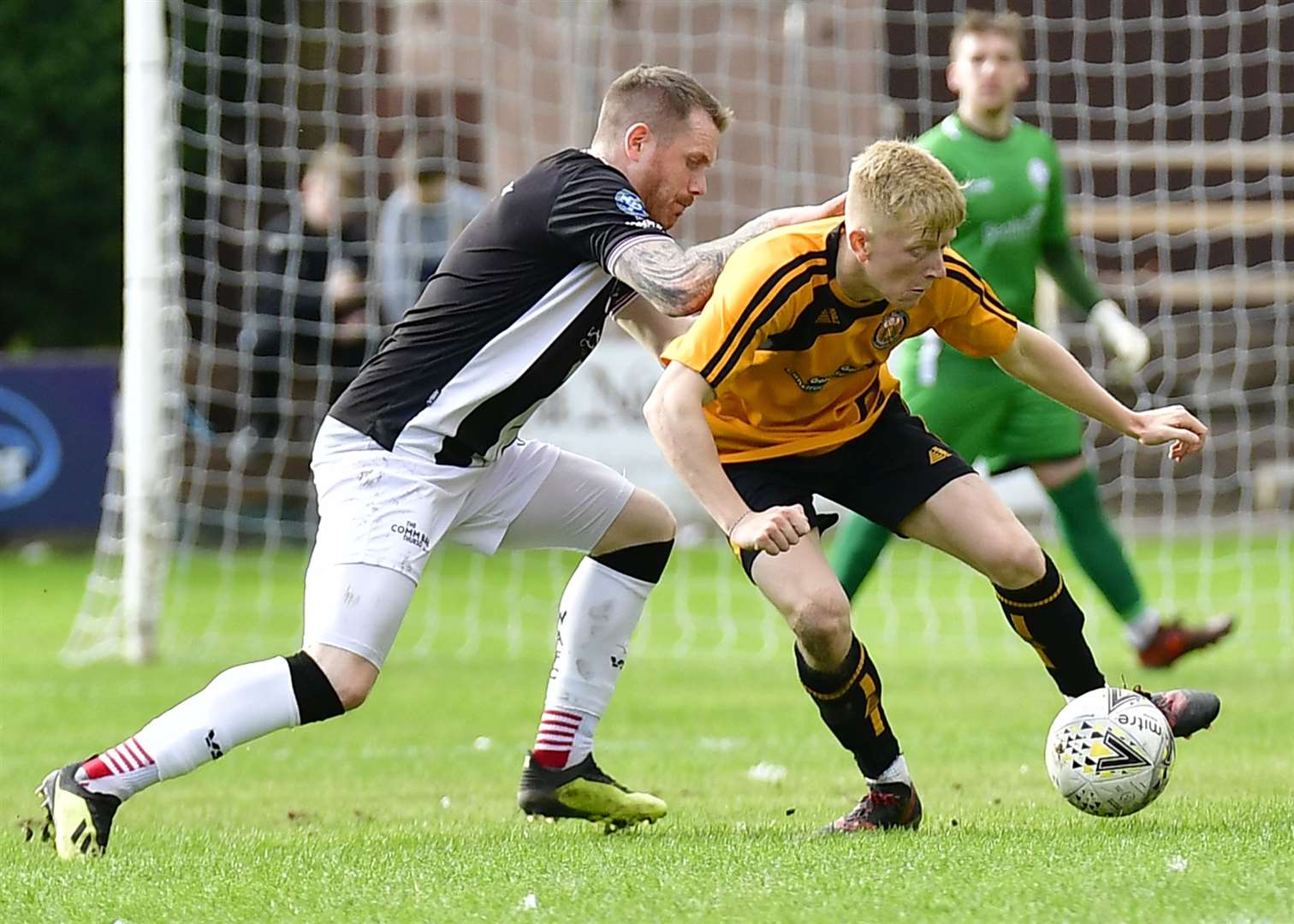 Ross Gunn is challenged by Craig Gunn in a Highland League tussle between Fort William and Wick Academy at Claggan Park in September. Picture: Mel Roger